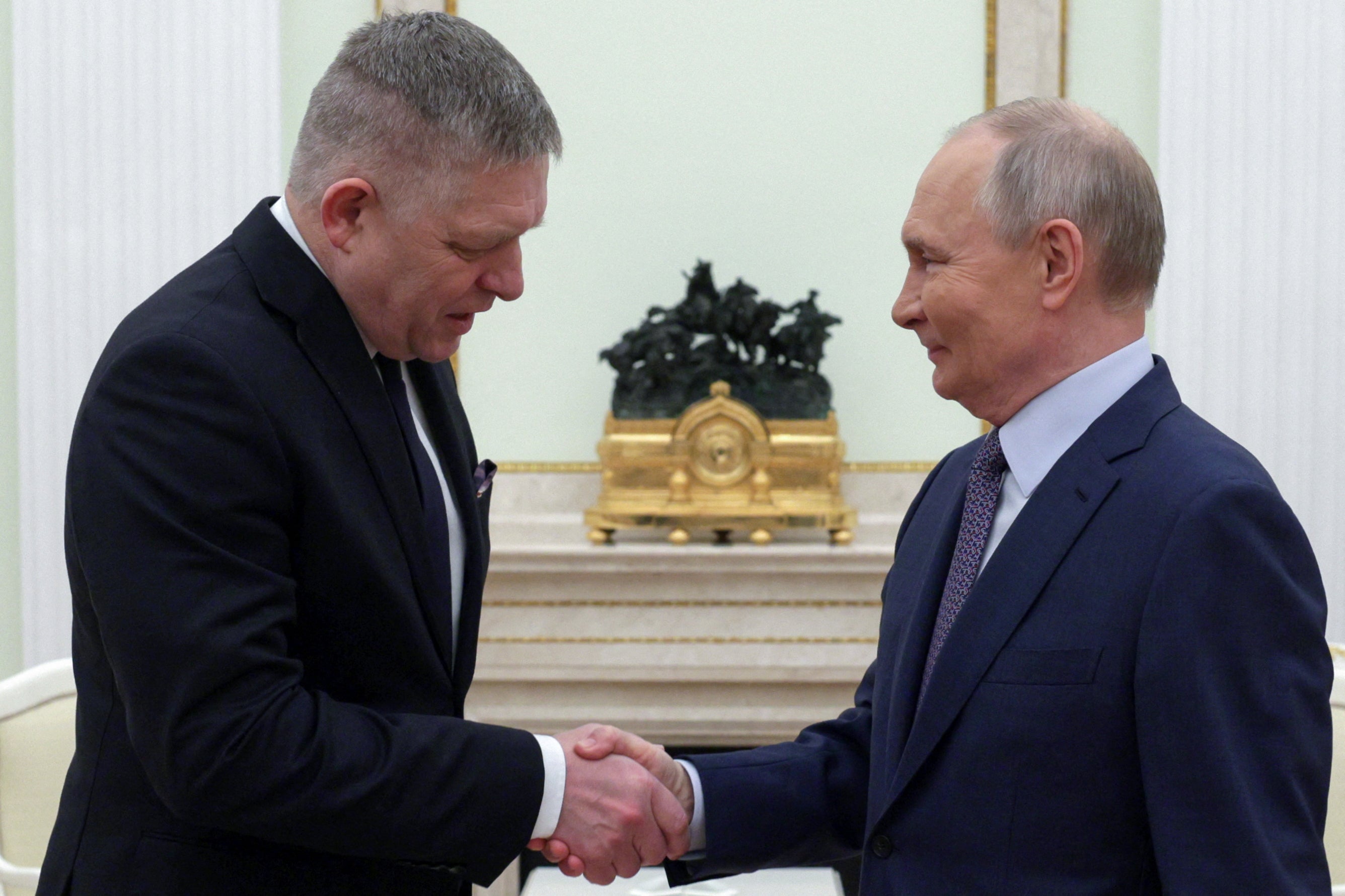 Vladimir Putin shakes hands with Slovakia’s prime minister Robert Fico prior to their talks in Moscow on 22 December 2024