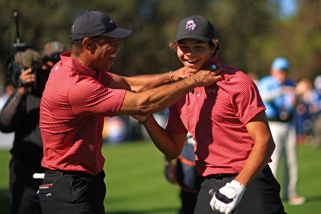 <p>Tiger Woods and Charlie, 15, celebrate the hole in one </p>