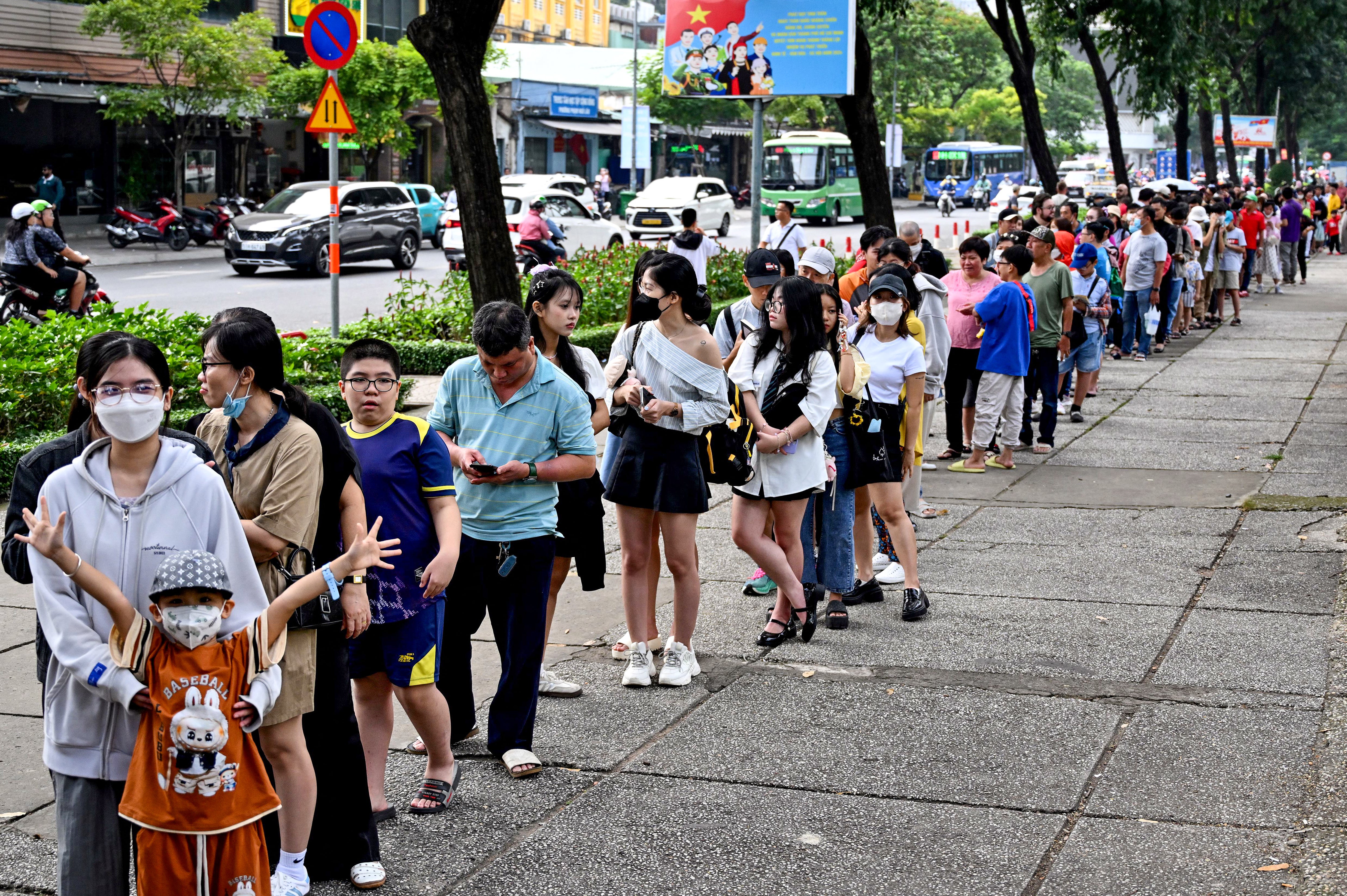 People line up as they arrive at a metro station in Ho Chi Minh City on 22 December 2024. Thousands of selfie-taking Ho Chi Minh City residents crammed into train carriages on 22 December, as the traffic-clogged business hub celebrated the opening of its first-ever metro line after years of delays