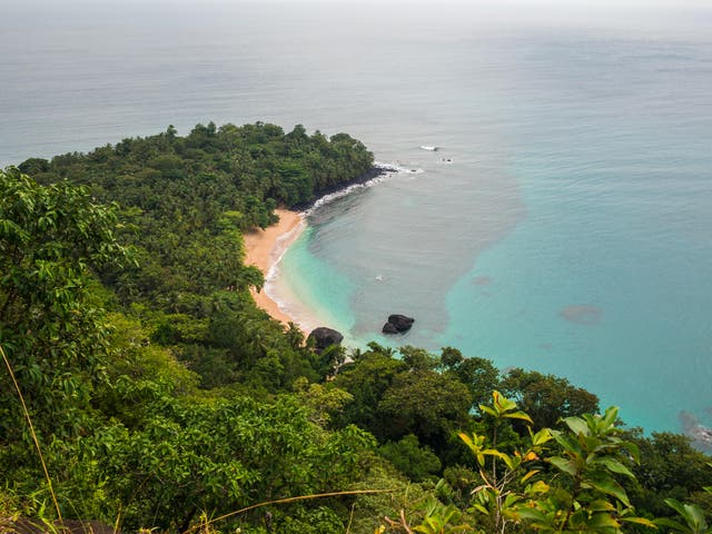 <p>The crescent of sand on Banana Beach in Principe</p>