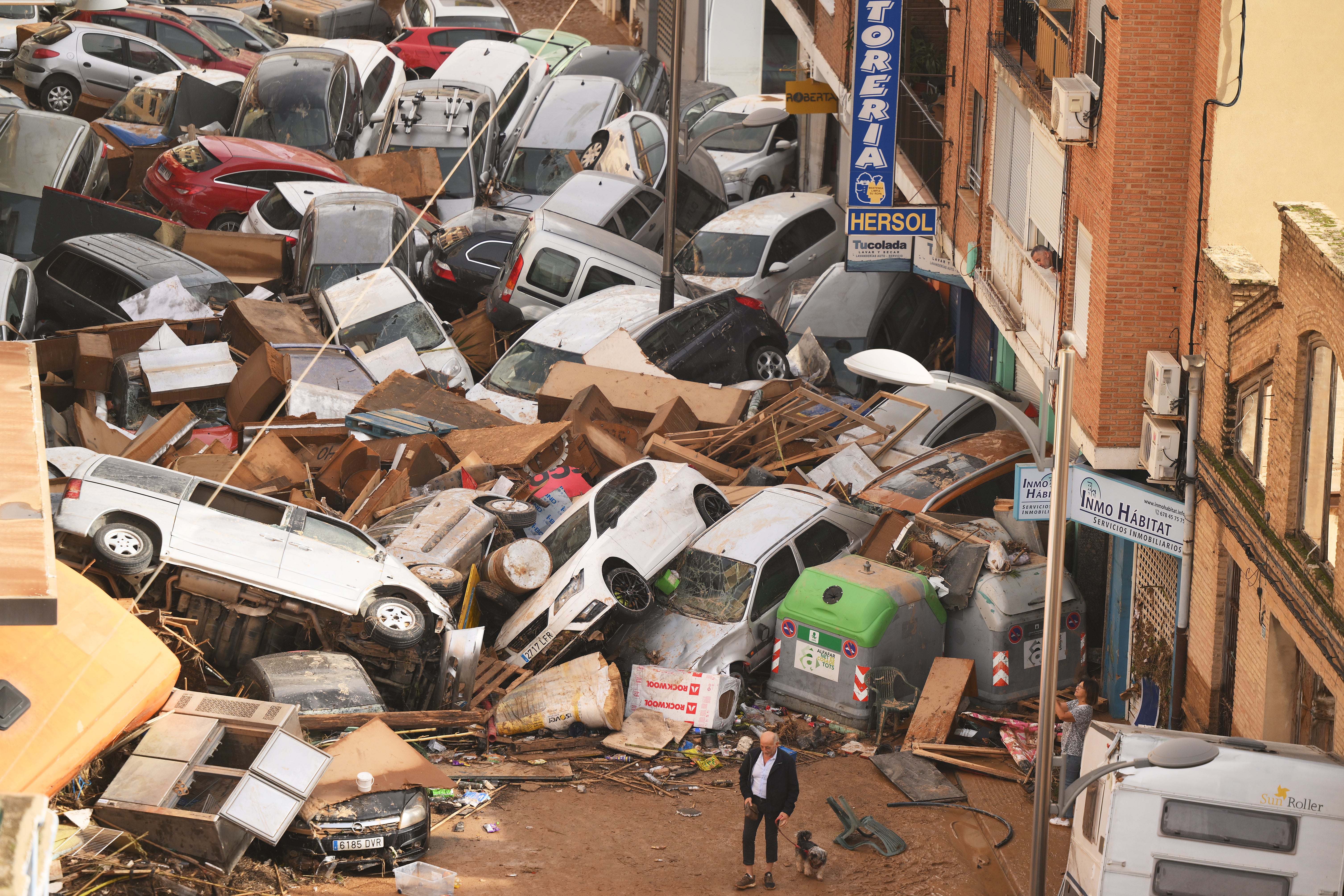 Cars are piled in the street with other debris after flash floods hit the region in October 2024 in Valencia, Spain.