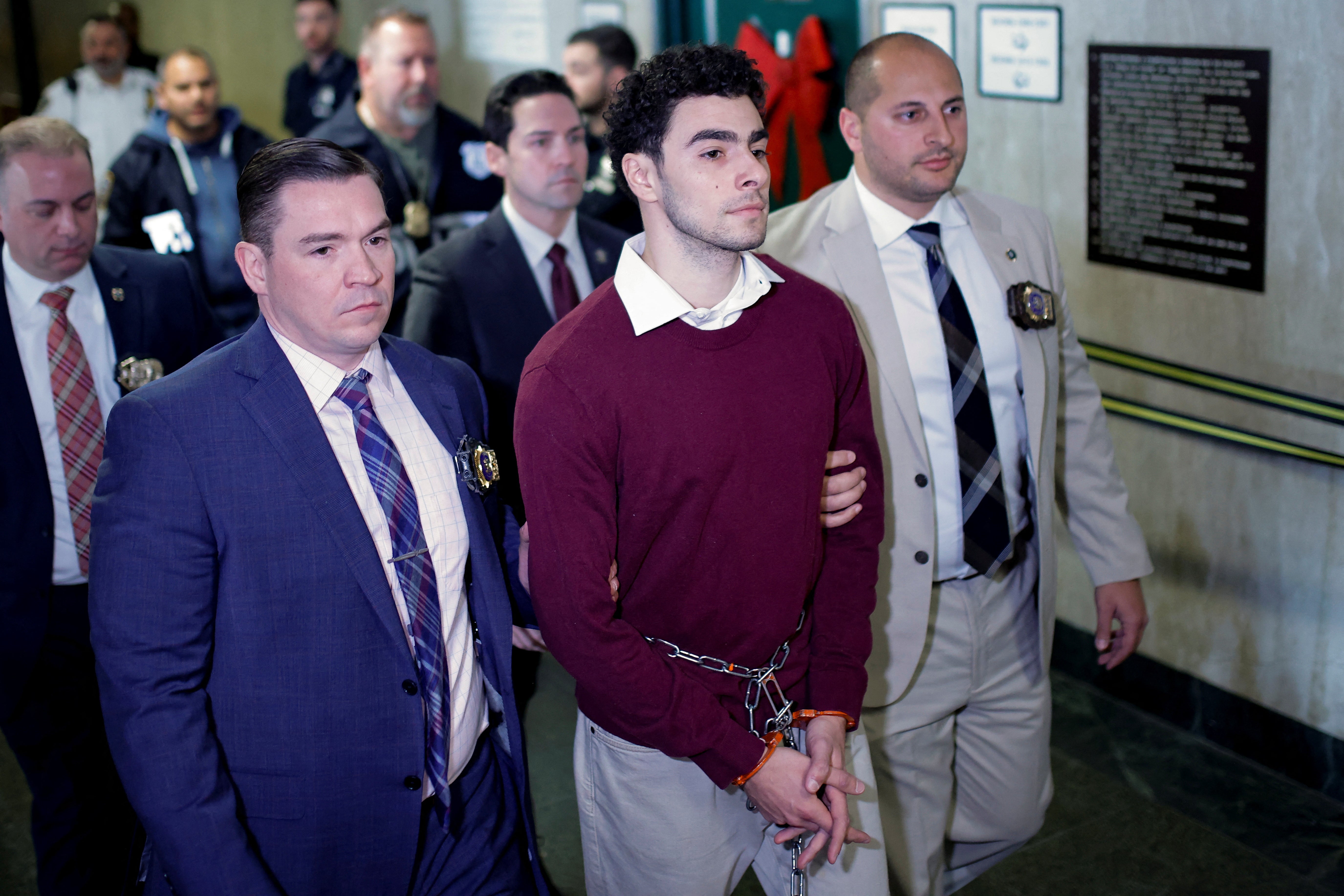 Luigi Mangione is escorted to his New York arraignment on December 23. The 26-year-old pleaded not guilty to the 11 charges he faces in the state