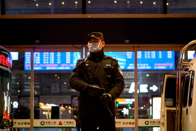 <p>A policeman stands on guard at  Changsha railway station</p>