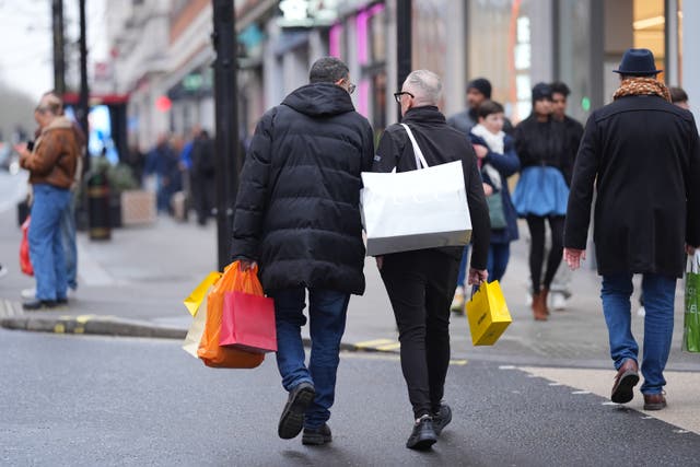 <p>Last-minute shoppers on Christmas Eve in Oxford Street, central London</p>