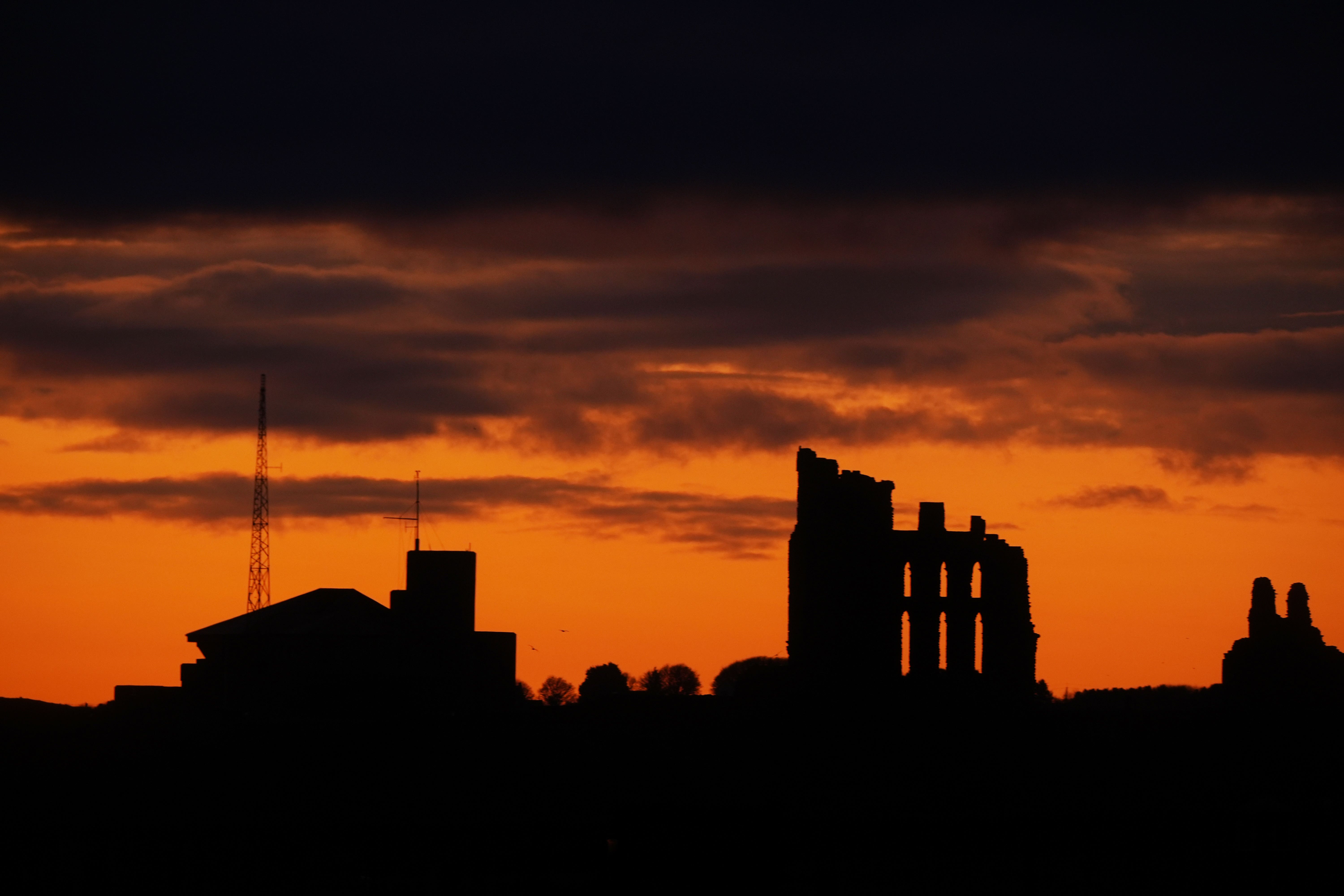 Dawn breaks over Tynemouth Priory as the Met Office forecast a ‘mild Christmas’ (Owen Humphreys/PA)