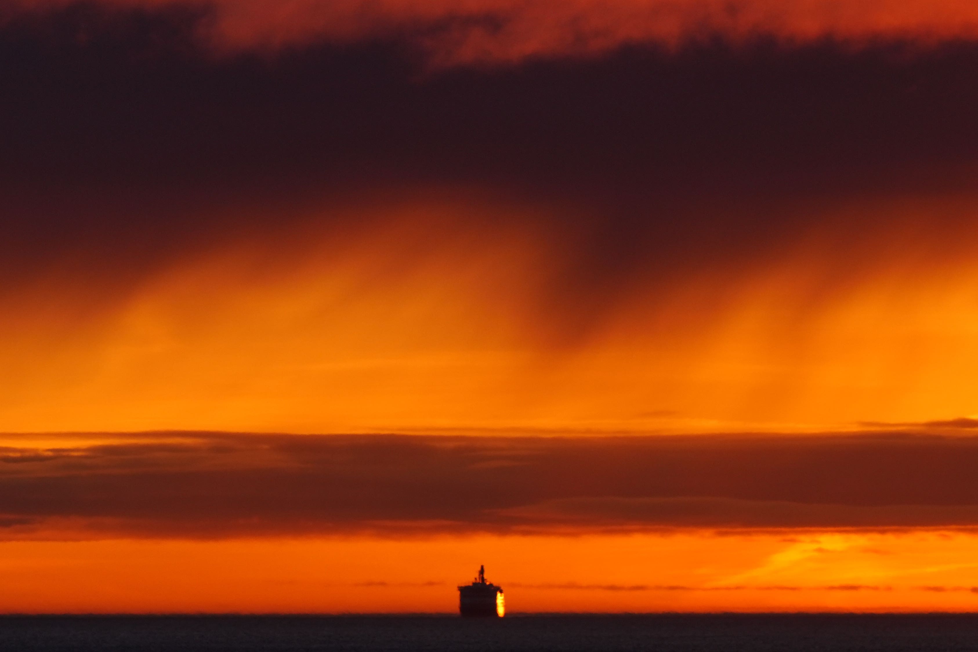 The DFDS King Seaways arrives during the sunrise on the North Sea to the mouth of the Tyne (Owen Humphreys/PA)