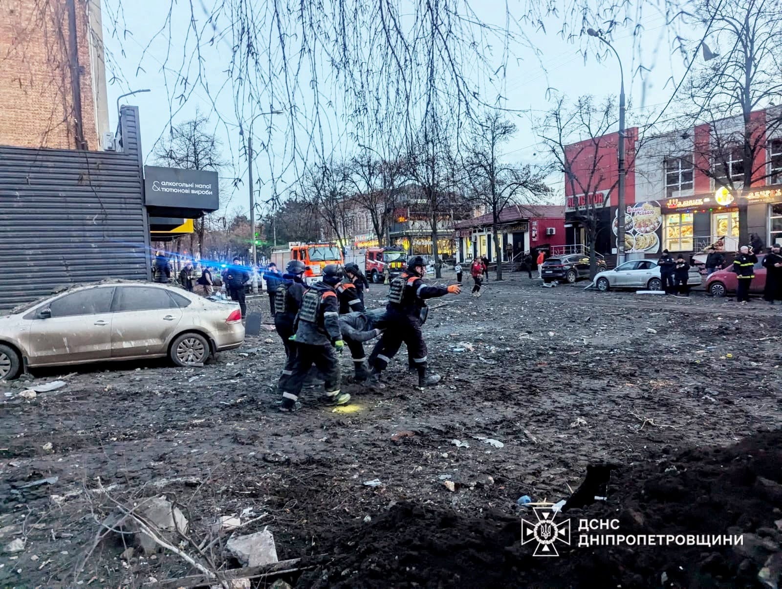 Rescuers evacuate a local resident from a residential building heavily damaged during a Russian missile attack