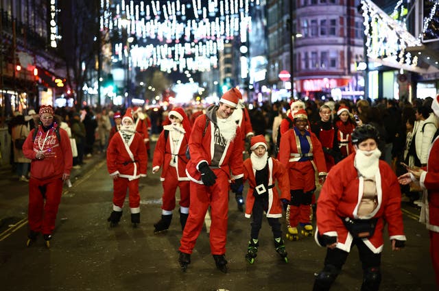 <p>Skaters in festive fancy dress, some as Santa or Father Christmas, attend a Christmas-themed SantaSkate through central London, on Oxford Street, on December 14, 2024.</p>