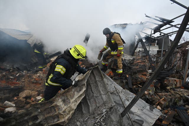 <p>Rescuers of Ukraine’s State Emergency Service work to put out a fire in a private house after a drone strike in Kharkiv</p>