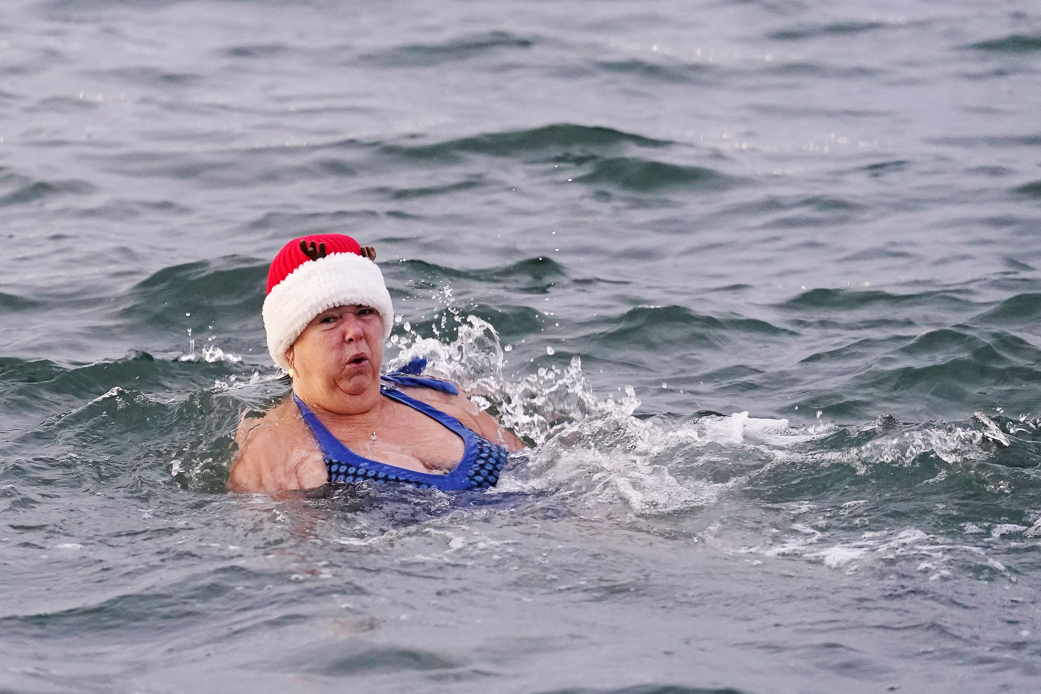 A woman enjoys a Christmas Day dip (Brian Lawless/PA)