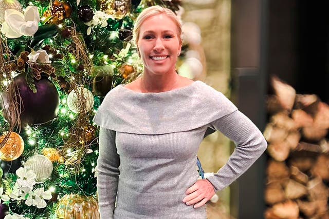 <p>MAGA’s Marjorie Taylor Greene shares a holiday photo in front of a Christmas tree </p>