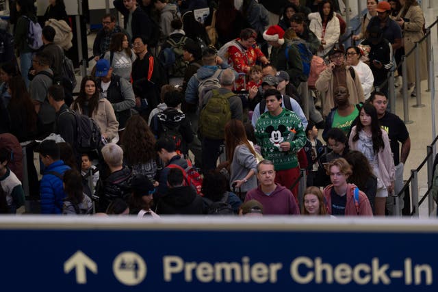 <p>Travelers wait in line for security checks at the Los Angeles International Airport in Los Angeles, California, on Tuesday. Severe weather could cause major delays on Thursday and Friday</p>