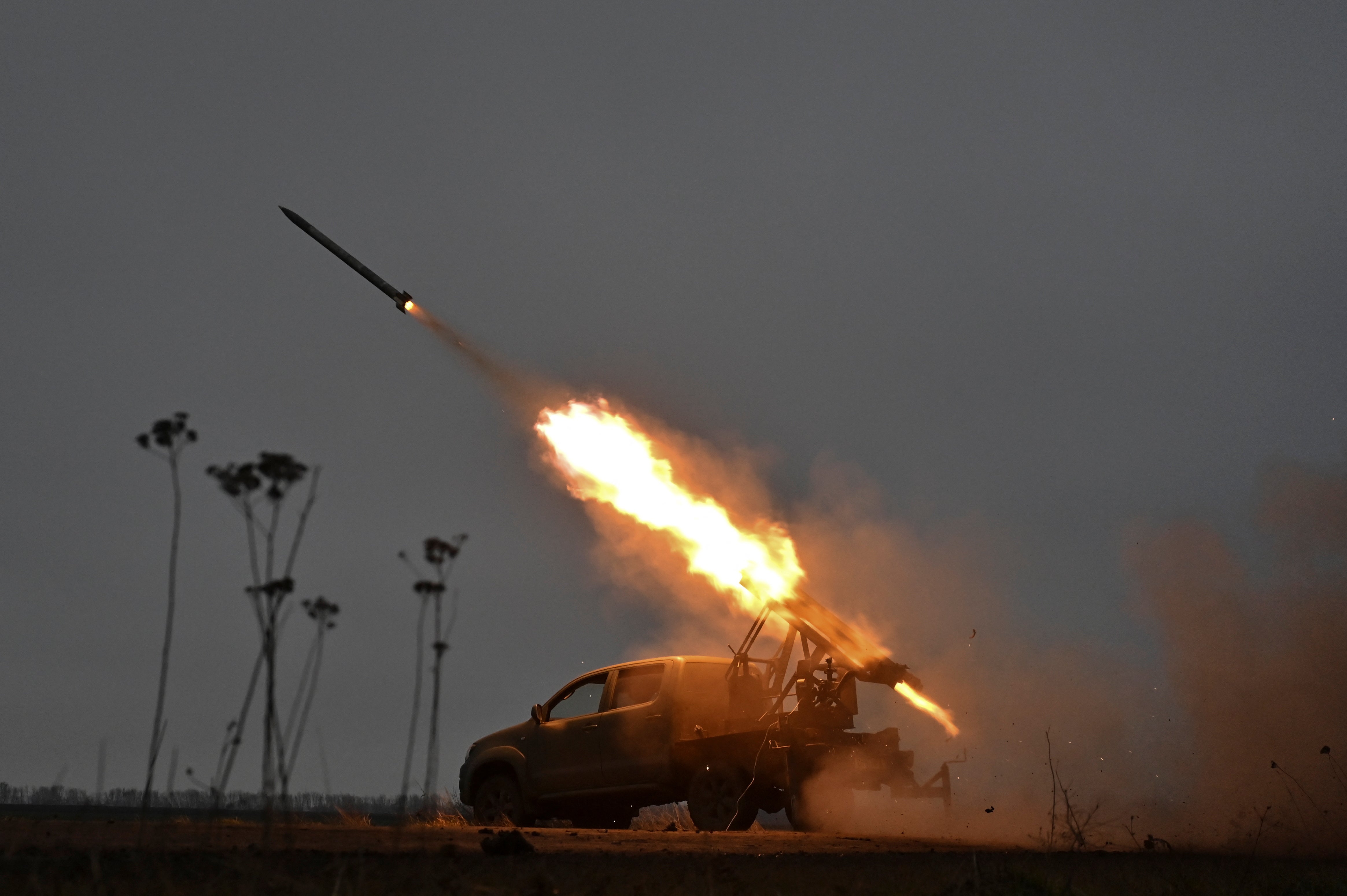 Members of the artillery unit of the special rifle battalion of Zaporizhzhia region police fire a small multiple launch rocket system (MLRS) towards Russian troops in a front line.