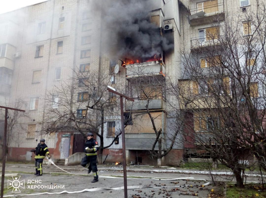 firefighters pushing out a fire after a shell explosion in a residential building from a Russian shelling in Bilozerka village, Kherson region.