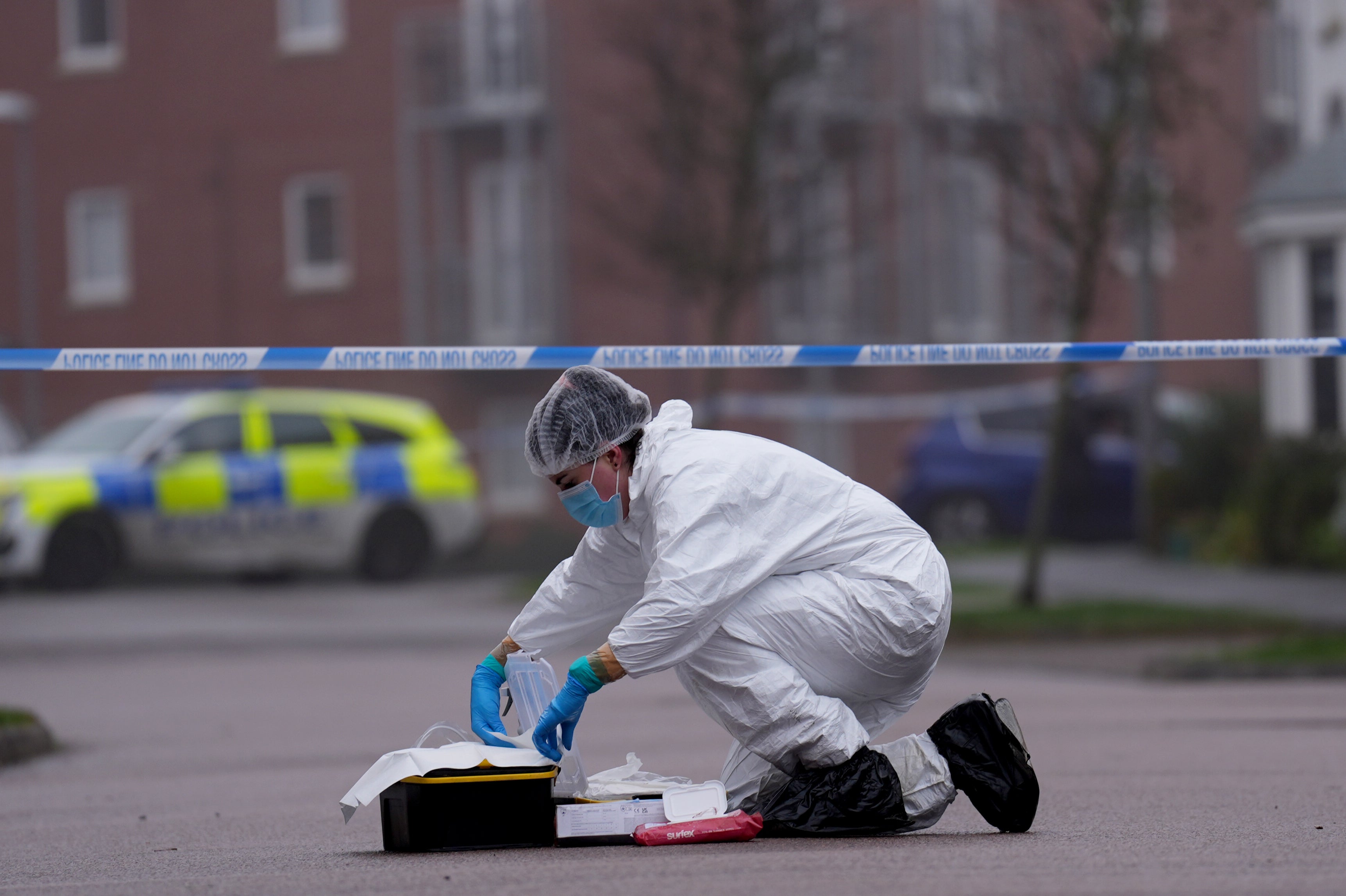 A police forensic officer at the scene near an apartment block on Santa Cruz Avenue in Newton Leys, near Bletchley