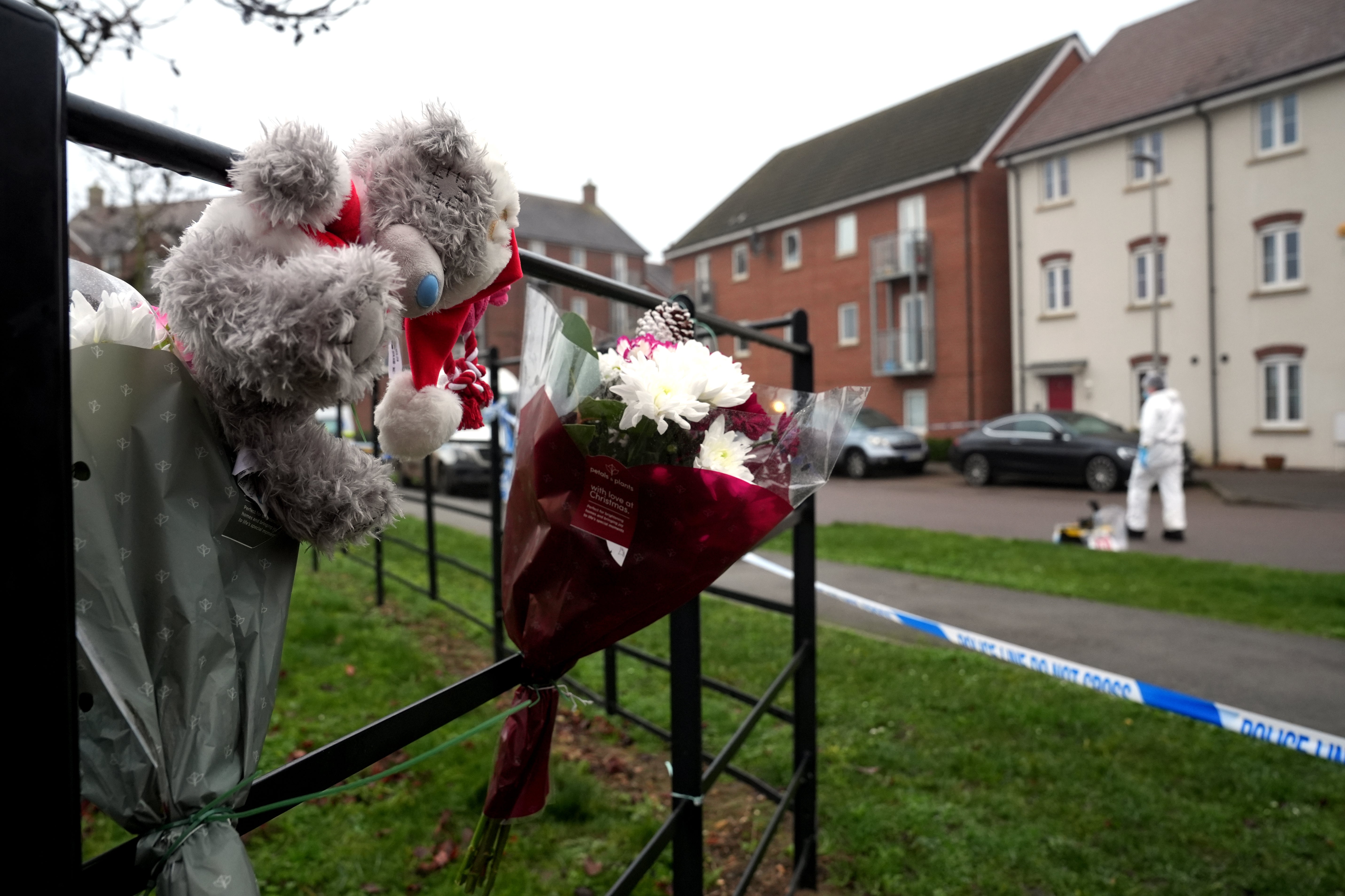 Tributes left near the police cordon in Newton Leys, near Bletchley, after two women were killed in an alleged Christmas Day stabbing