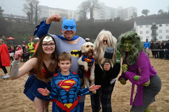 People take part in the annual Tenby Boxing Day swim dressed as superheroes (Gareth Davies Photography/Tenby Boxing Day Swim/PA)
