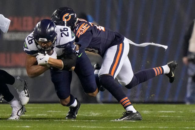 Seattle Seahawks running back Zach Charbonnet is tackled by Chicago Bears cornerback Tyrique Stevenson (Nam Y Huh/AP)