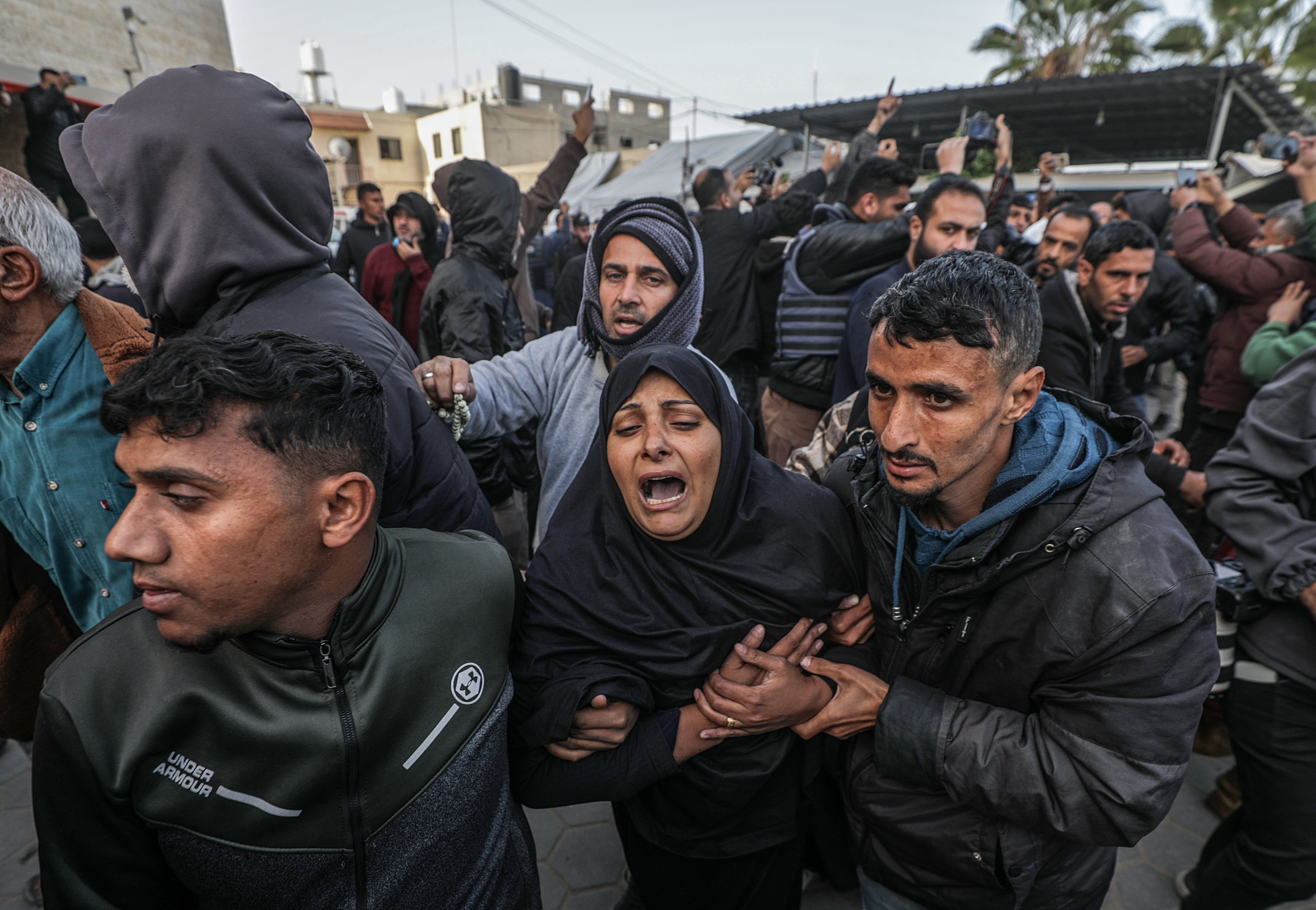 Mourners react during the funeral of Palestinian journalists killed in an overnight Israeli airstrike in Al Nuseirat refugee camp