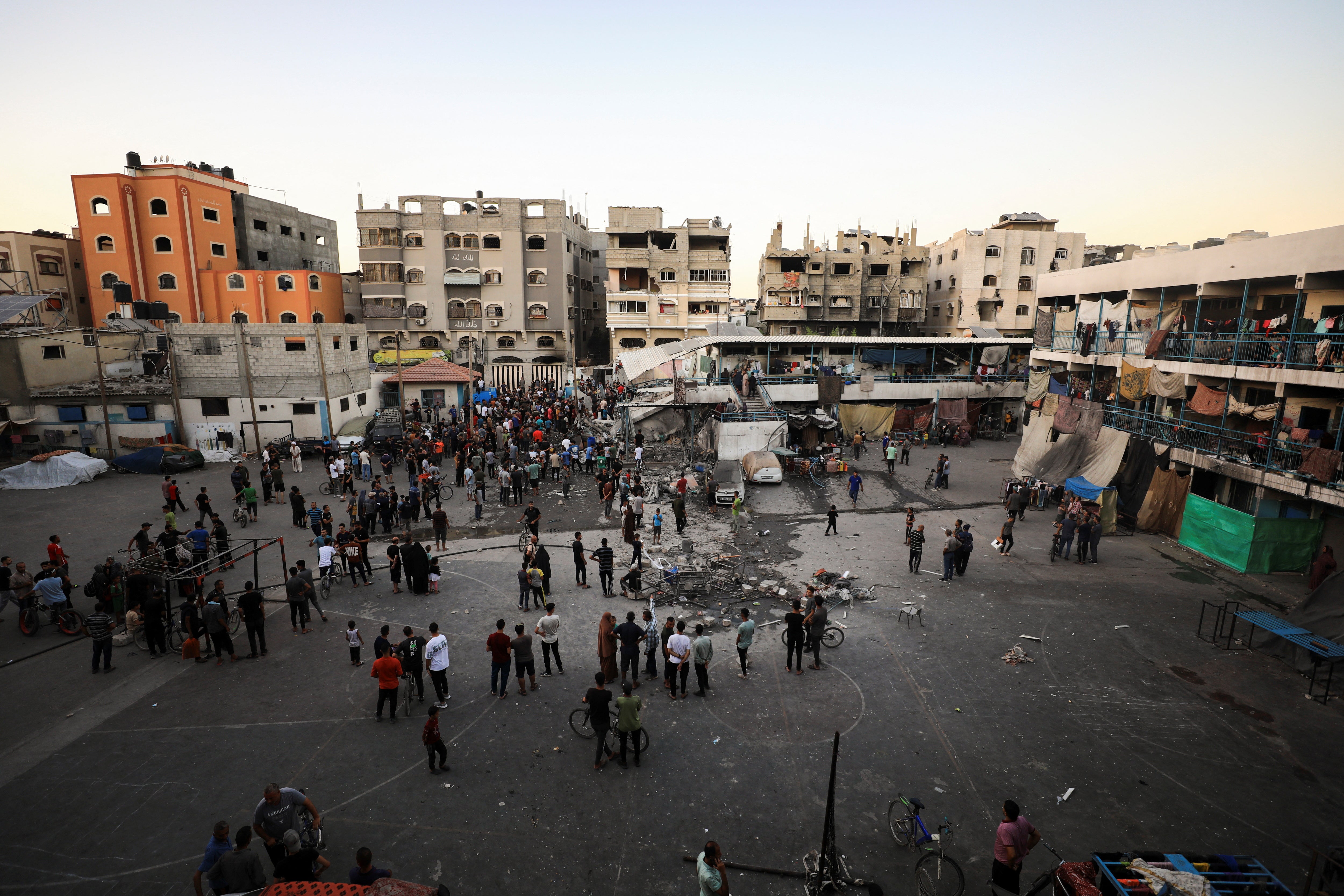 Palestinians gather at a UN school sheltering displaced people following an Israeli strike in Gaza