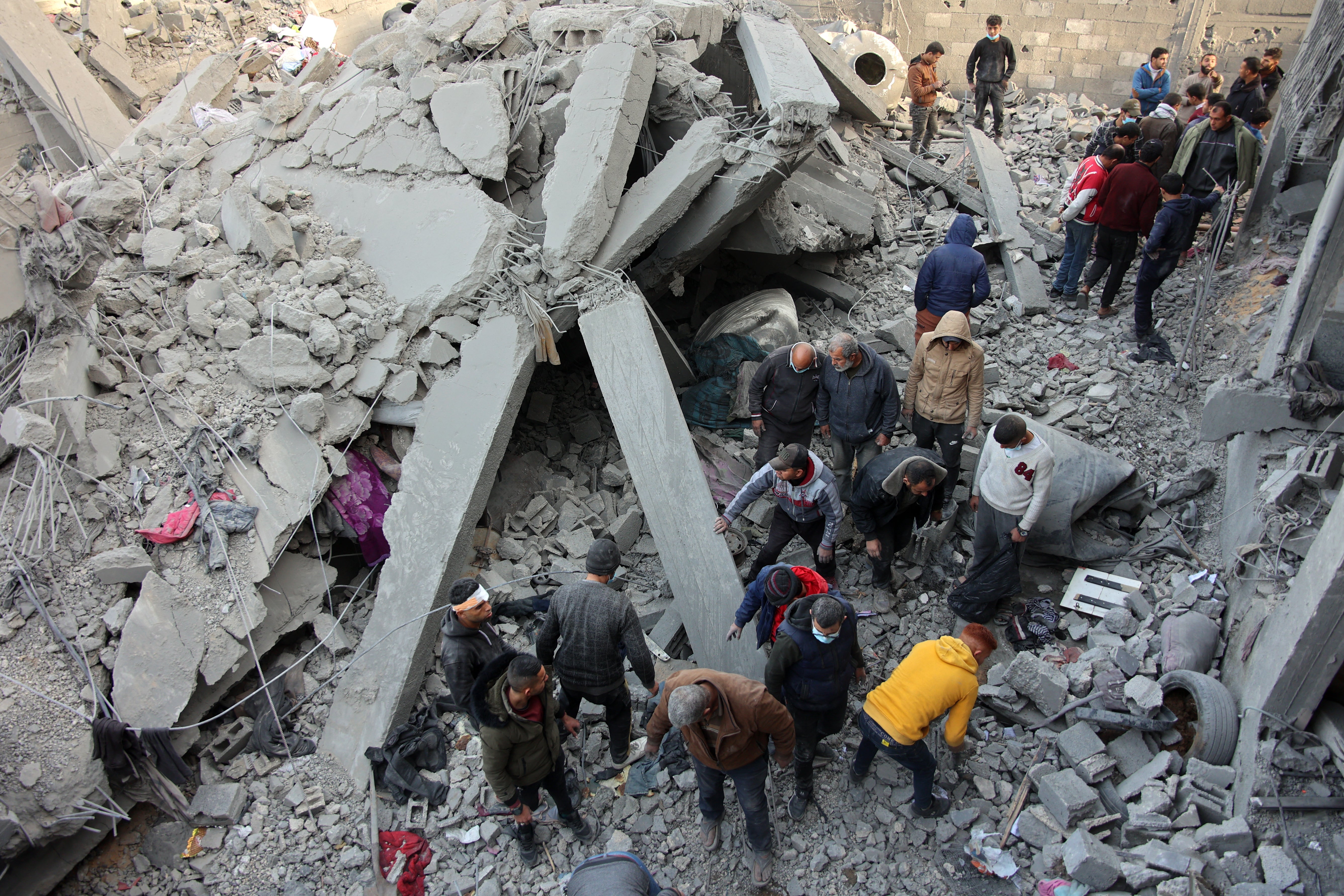 Civilians check the site of an Israeli strike in Jabalia in the Gaza Strip