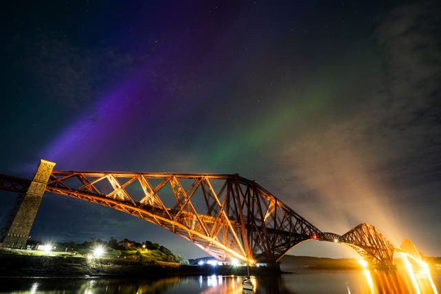 The aurora borealis, also known as the Northern Lights, above the Forth Bridge at North Queensferry in May (Jane Barlow/PA)