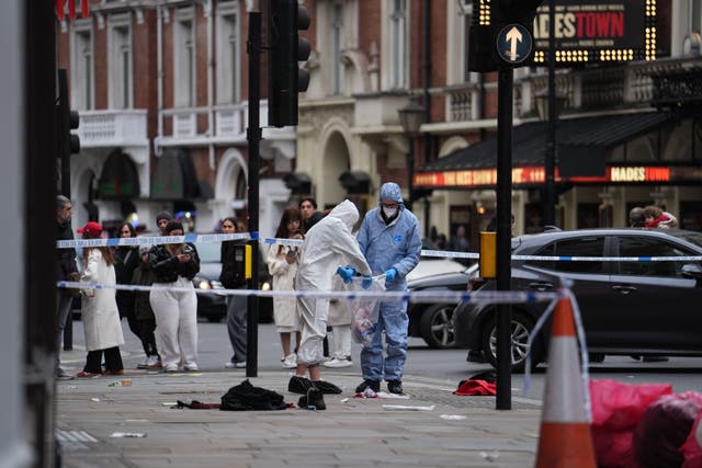 Forensic investigators collect evidence at the scene on Shaftesbury Avenue (Jordan Pettitt/PA)