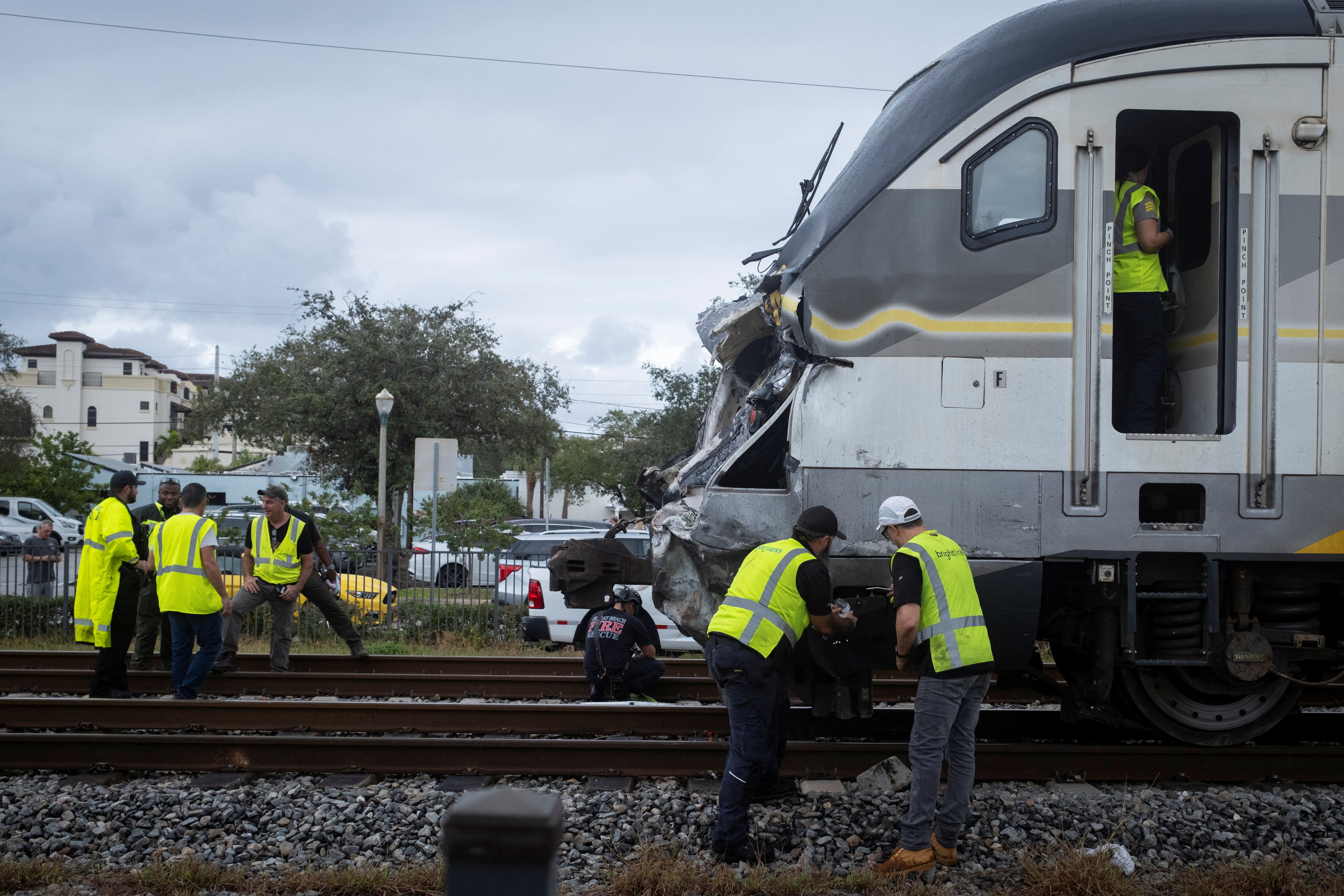 Delray Beach Police officers and Brighline personnel are seen at the scene after a Brightline passenger train collided with a fire truck on railtracks in Delray Beach, Florida, U.S. December 28, 2024