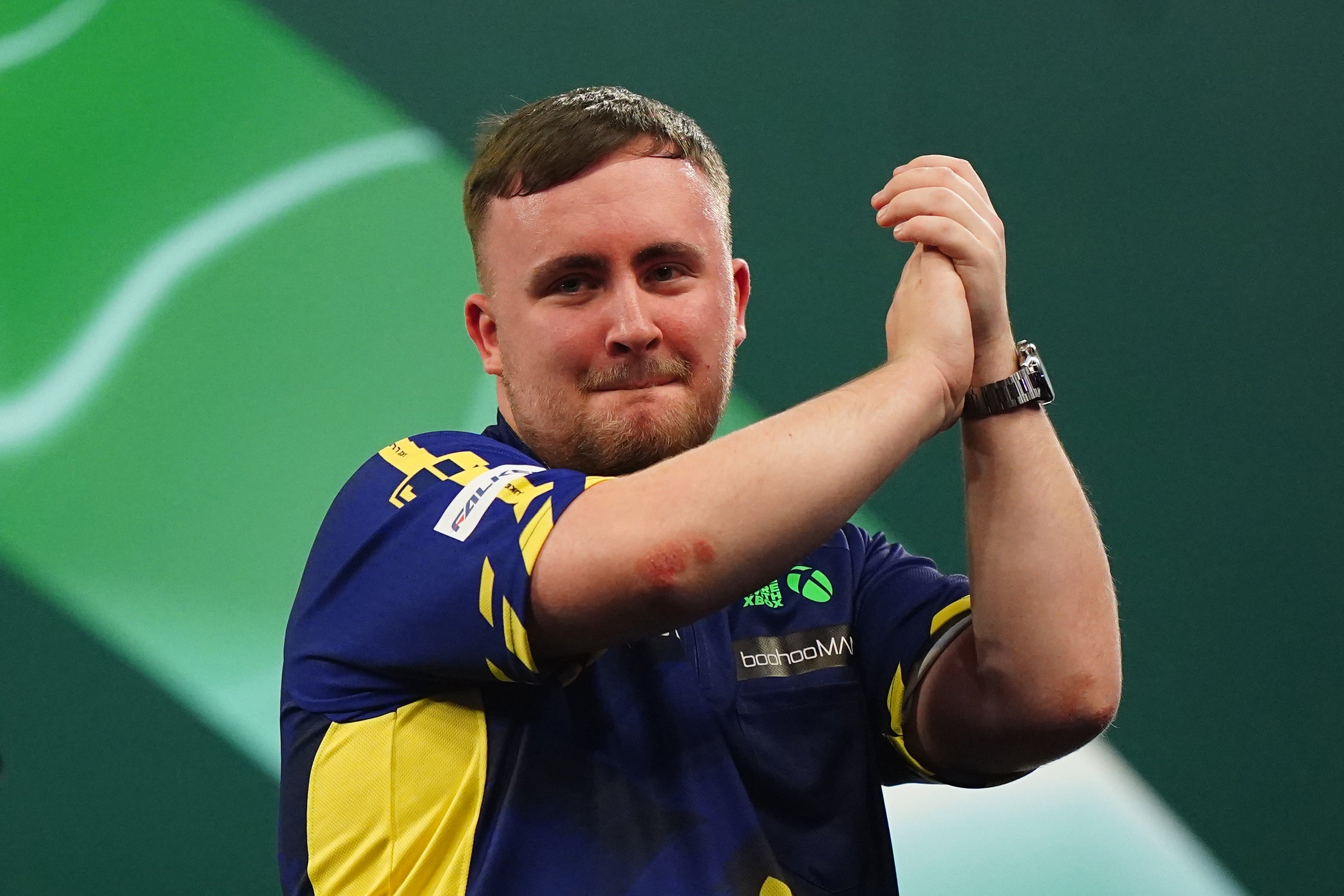 Luke Littler celebrates after winning his match against Ian White on day eleven of the Paddy Power World Darts Championship at Alexandra Palace