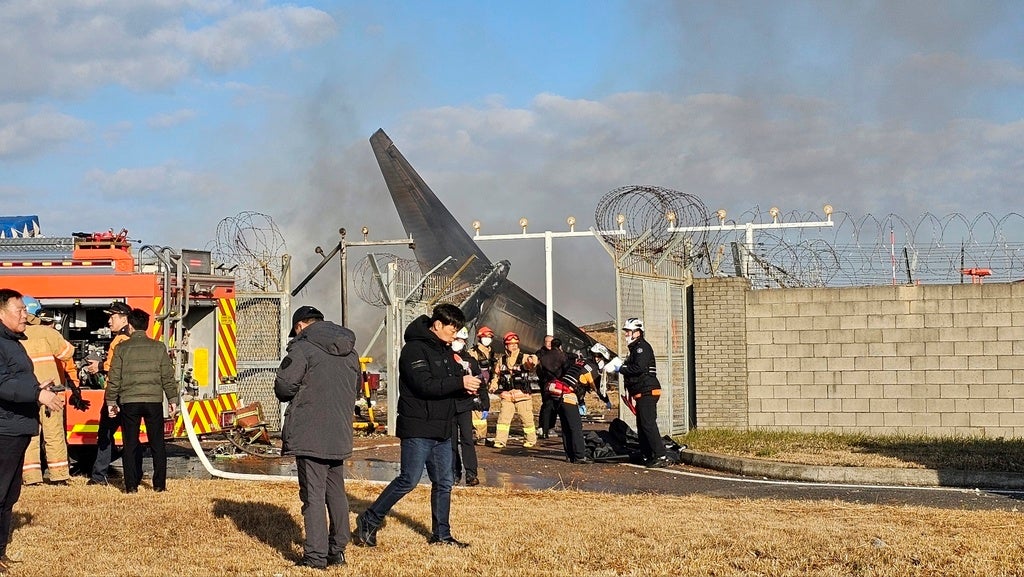 Firefighters and rescue team members work at the Muan International Airport in Muan, South Korea, Sunday, Dec. 29, 2024