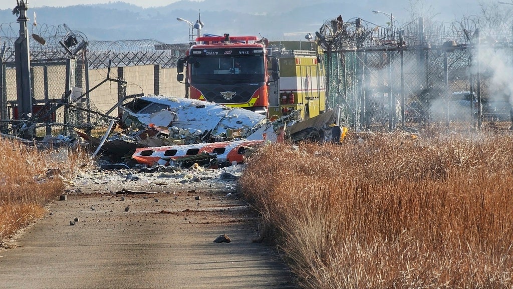 Fire engines work to extinguish a fire at the Muan International Airport in Muan, South Korea, Sunday, Dec. 29, 2024