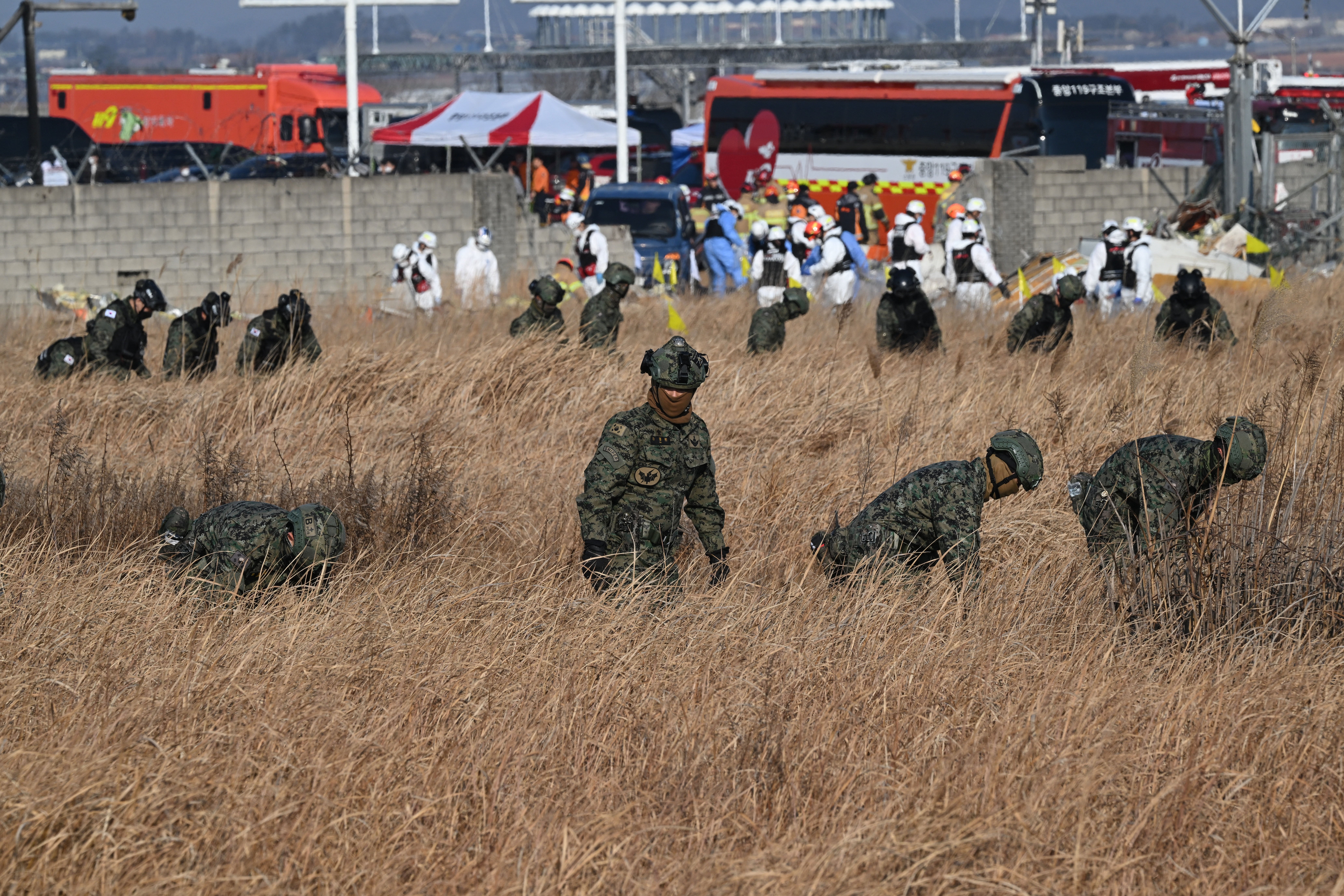 South Korean soldiers search for missing passengers near the wreckage of a Jeju Air Boeing 737-800 series aircraft in Muan town