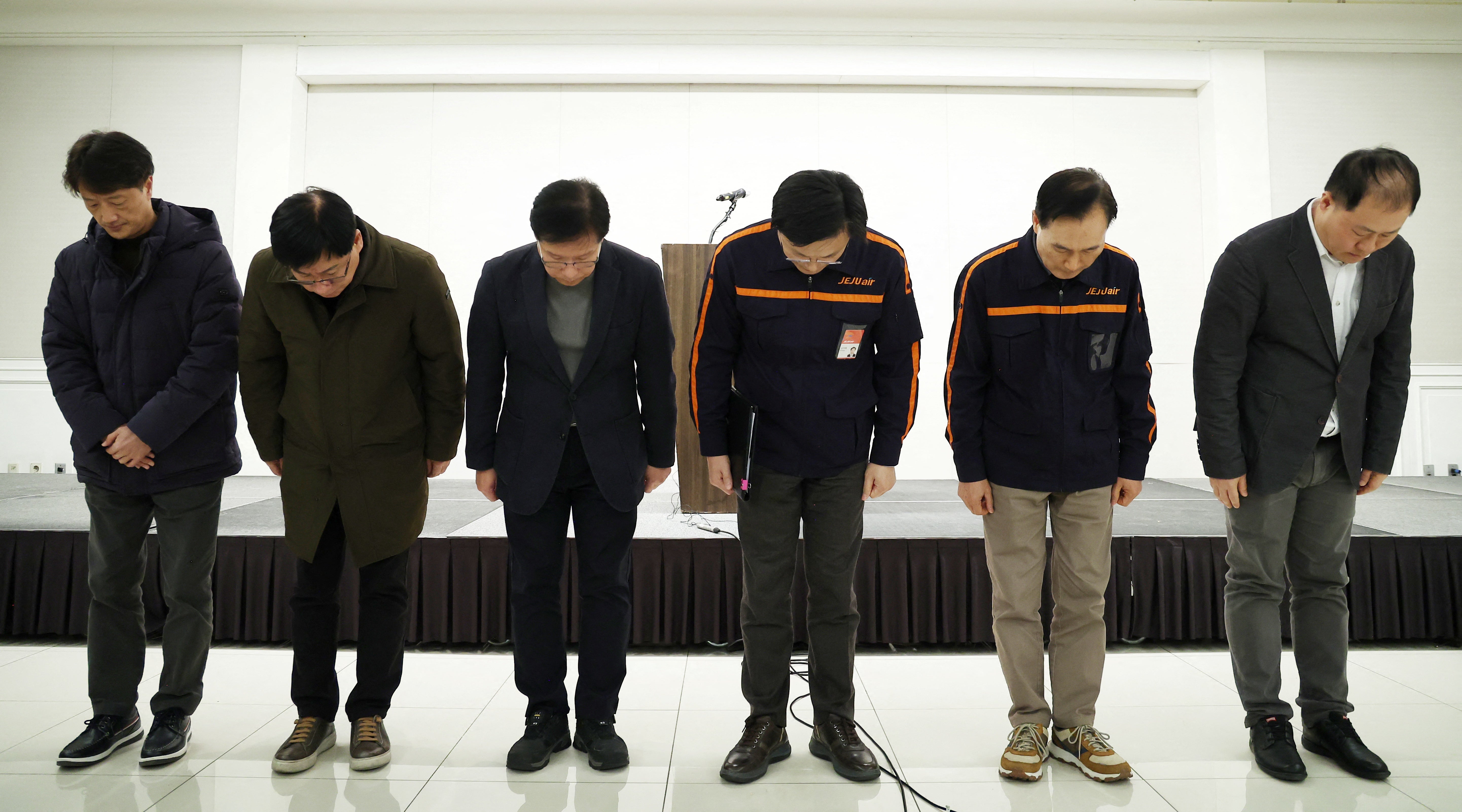 Jeju Air chief Kim E-bae (third from right) and other executive members bow in apology ahead of a briefing in Seoul