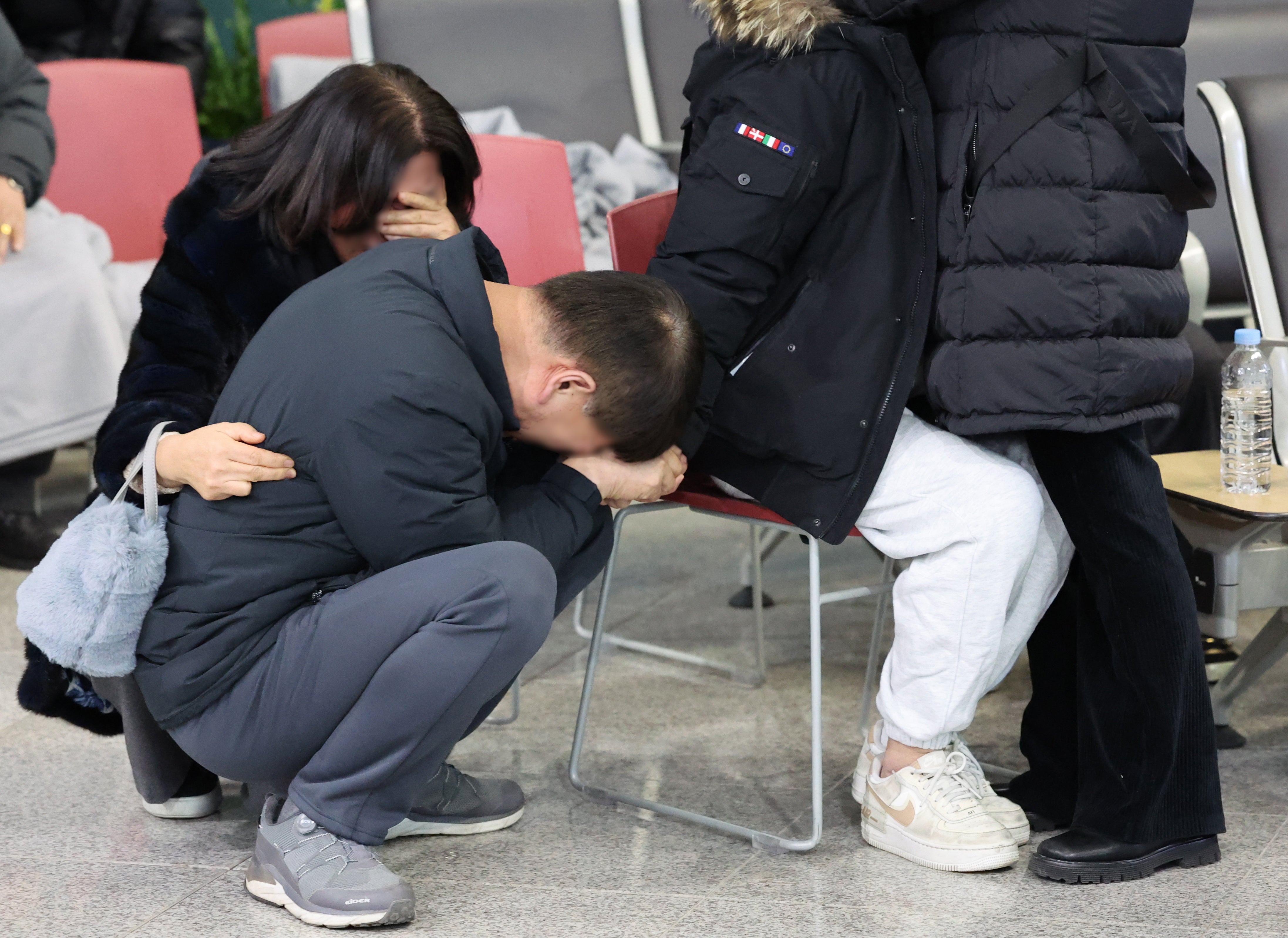 Family members of a victim of the Jeju Air crash grieve at Muan international airport as world leaders sent condolences to those impacted