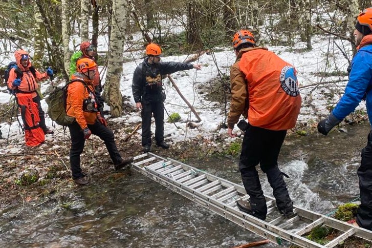 A rescue party searches for the two missing men in Washington forest