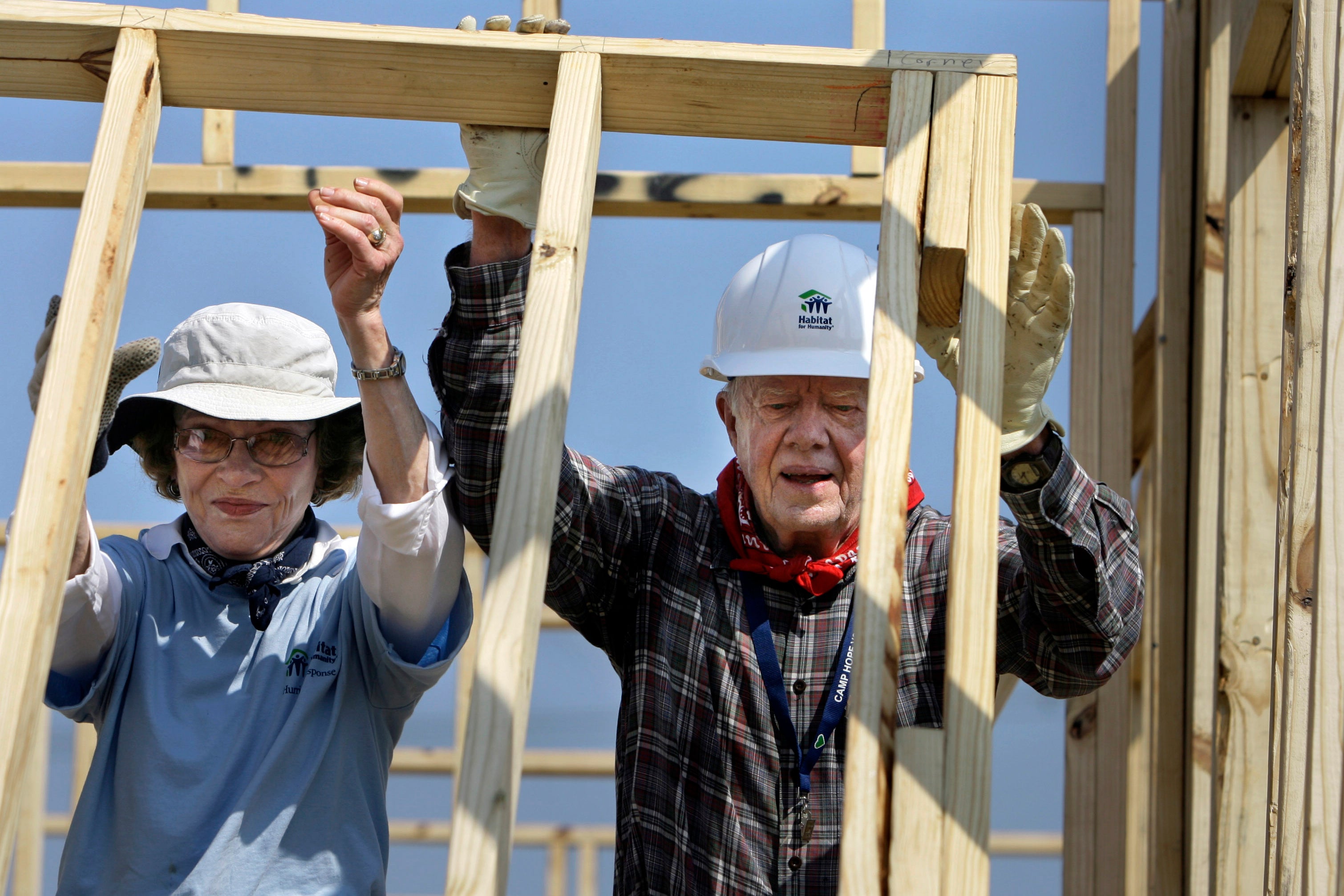 The Carters pictured in 2007 helping build a Habitat for Humanity house in Louisiana