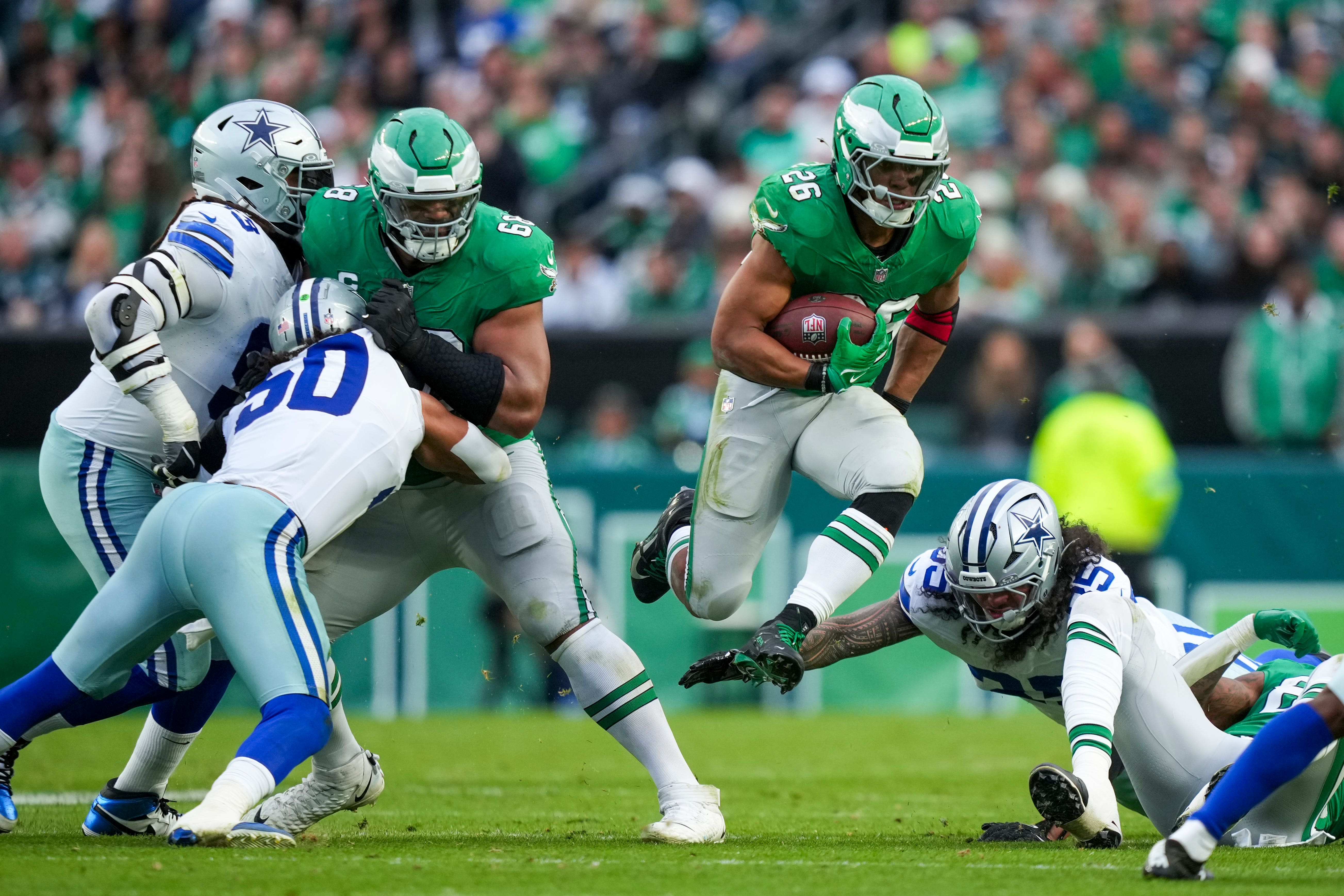 Philadelphia Eagles running back Saquon Barkley, with ball, is 100 yards short of Eric Dickerson’s NFL single-season rushing record of 2,105 yards (Matt Slocum/AP)