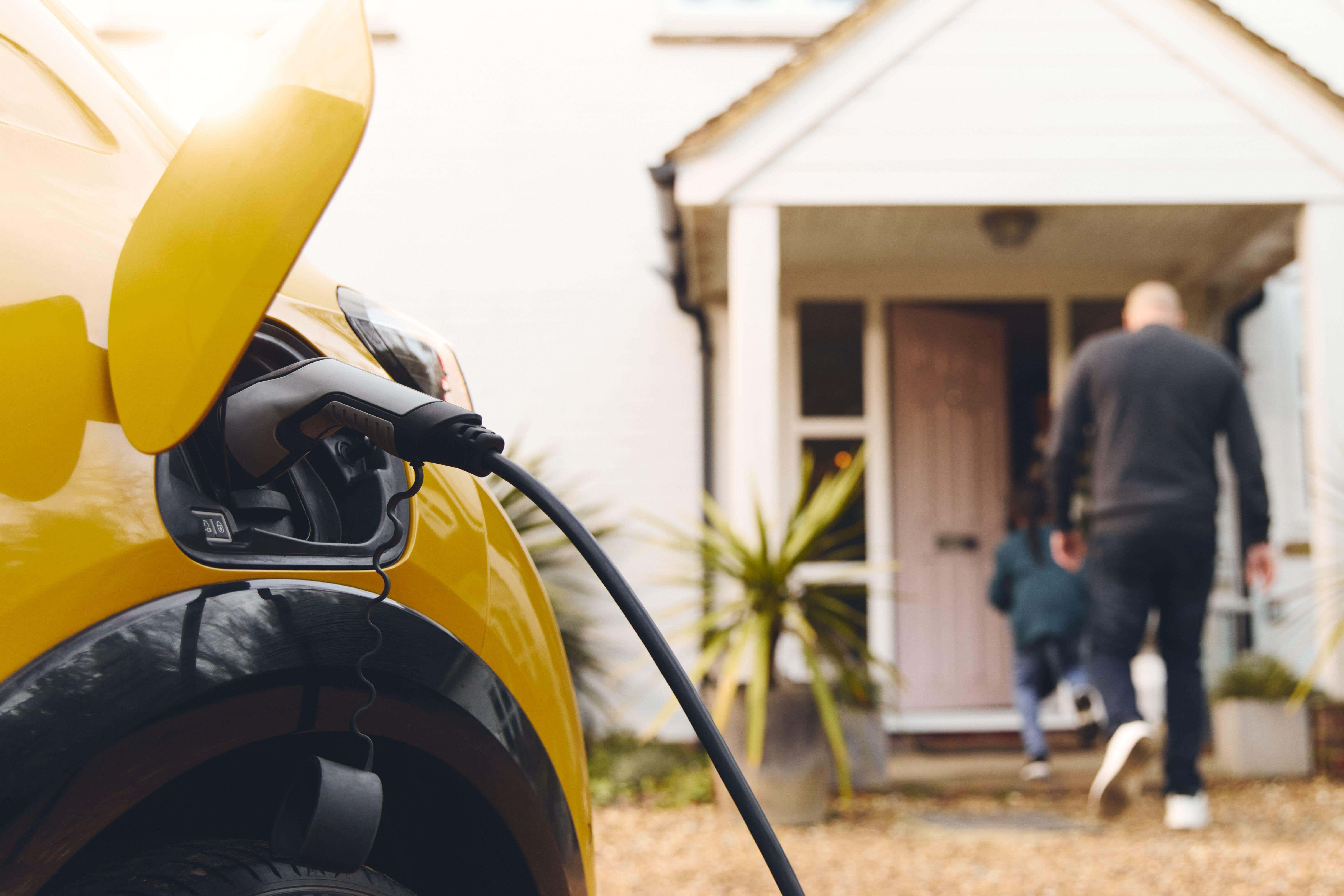 The EV boom means front gardens will increasingly have to enable charging – but can also provide space for plants (Alamy/PA)