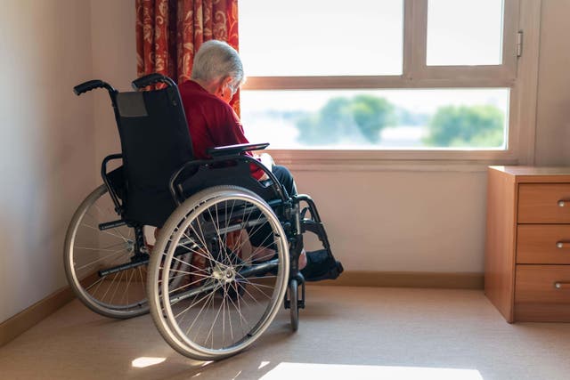 An elderly woman in a wheelchair (Alamy/PA)