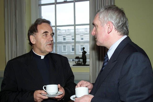 Father Aidan Troy talks to Irish premier Bertie Ahern (Chris Bacon/PA)