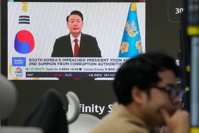 <p>A TV screen shows a file image of South Korean president Yoon Suk Yeol being broadcast at the KEB Hana Bank headquarters in Seoul on 26 December 2024</p>