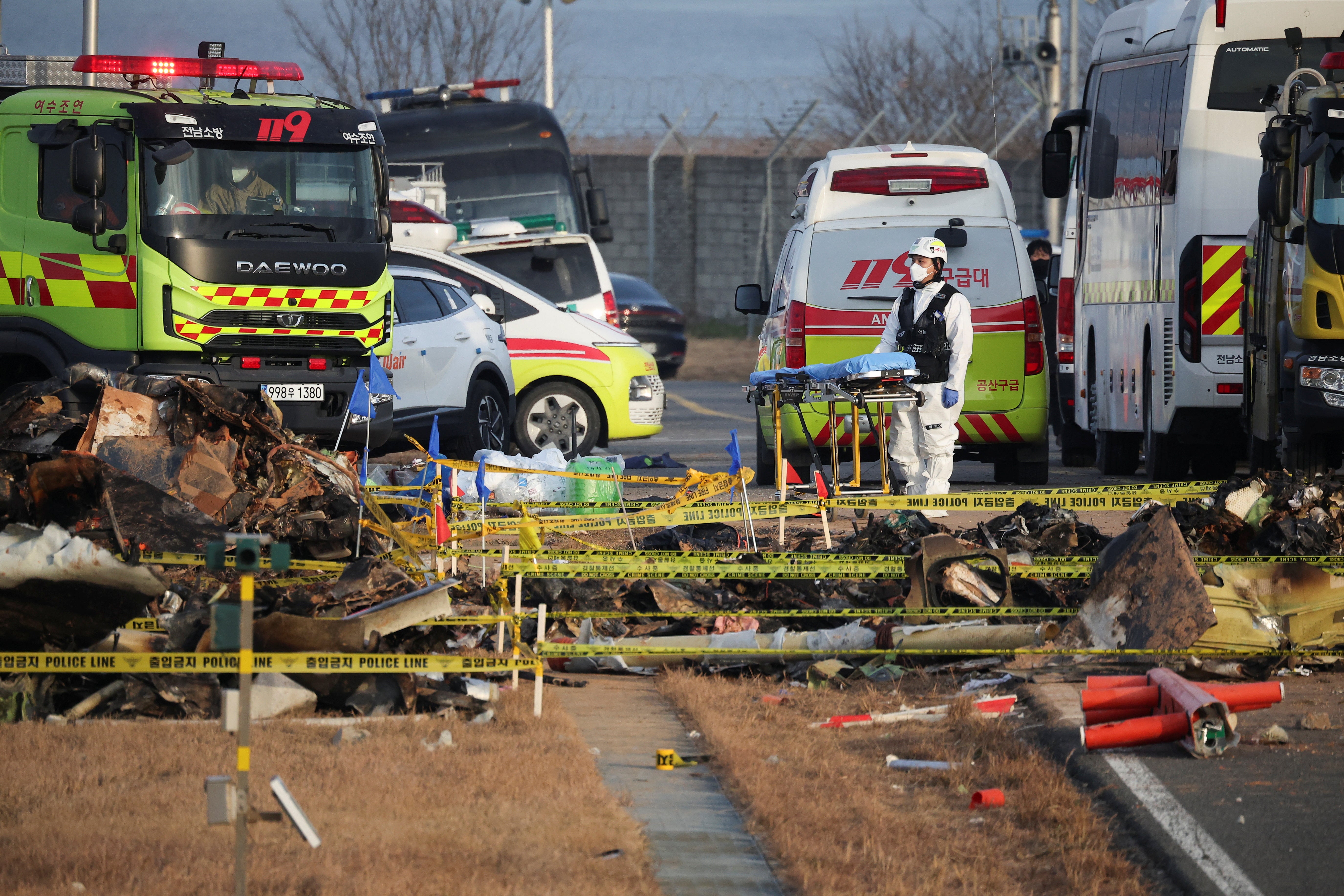 A rescue worker stands near the wreckage of the Jeju Air aircraft