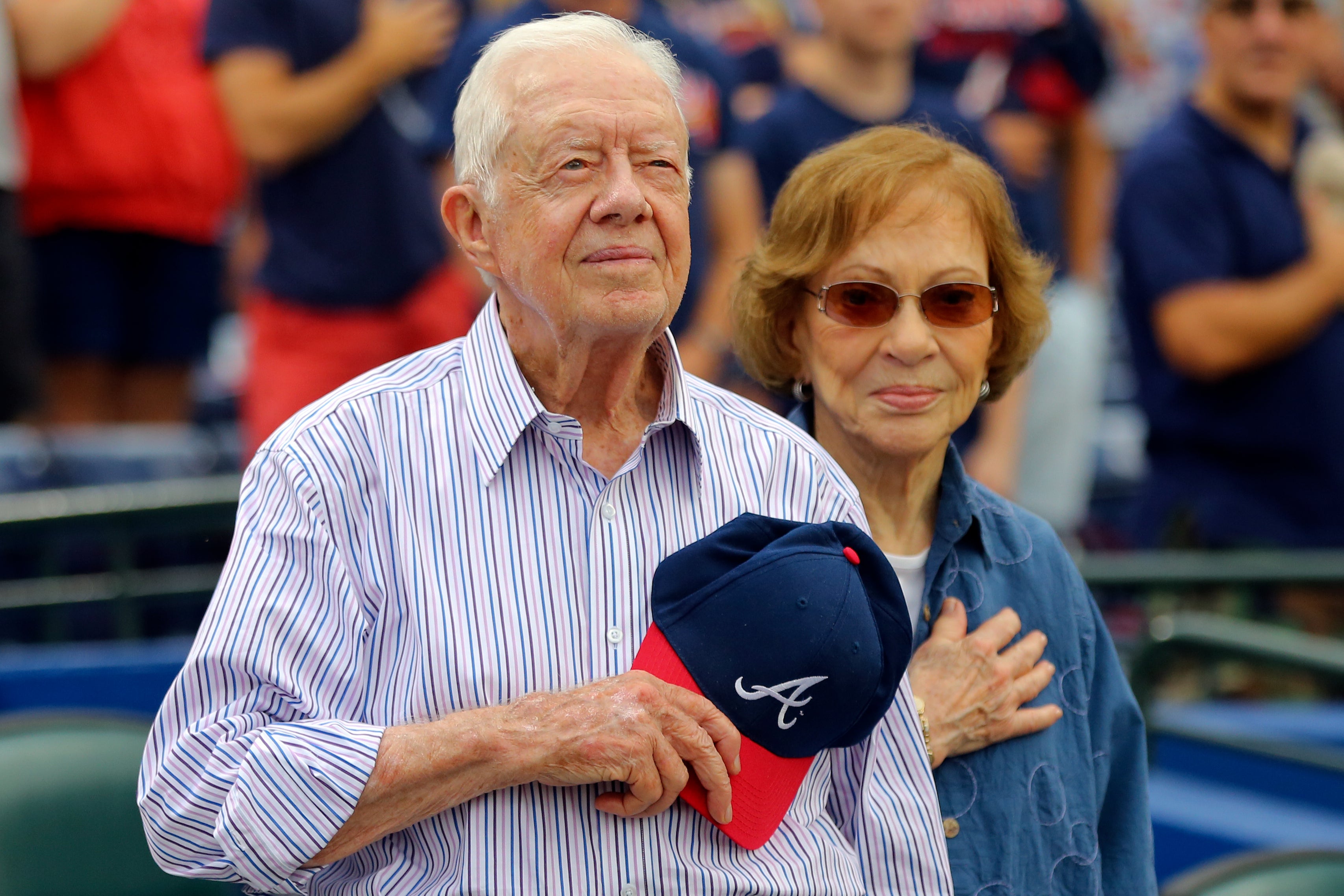 Carter and his wife, Rosalynn, stand for the national anthem before a baseball game in 2015