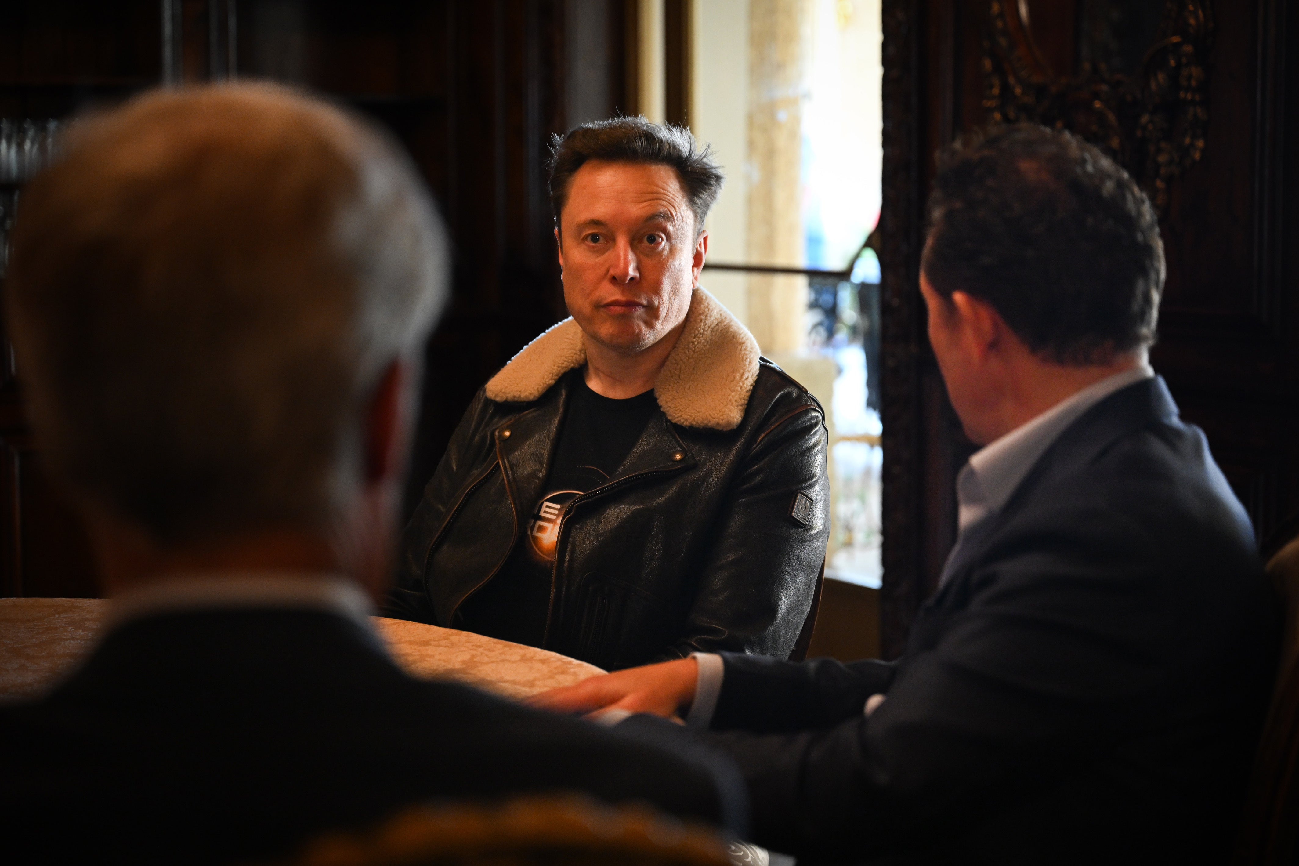 <p>Elon Musk, centre, met Reform UK’s Nigel Farage and Nick Candy at Mar-A-Lago, the Florida home of US President-elect Donald Trump (Stuart Mitchell/Reform UK/PA)</p>