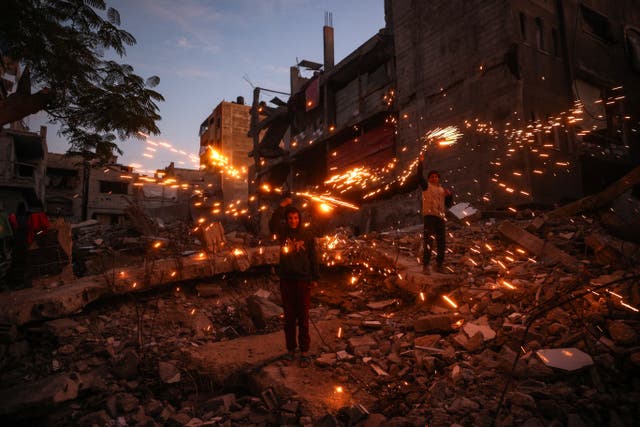 <p>Children play with fireworks at the Bureij camp for displaced Palestinians</p>