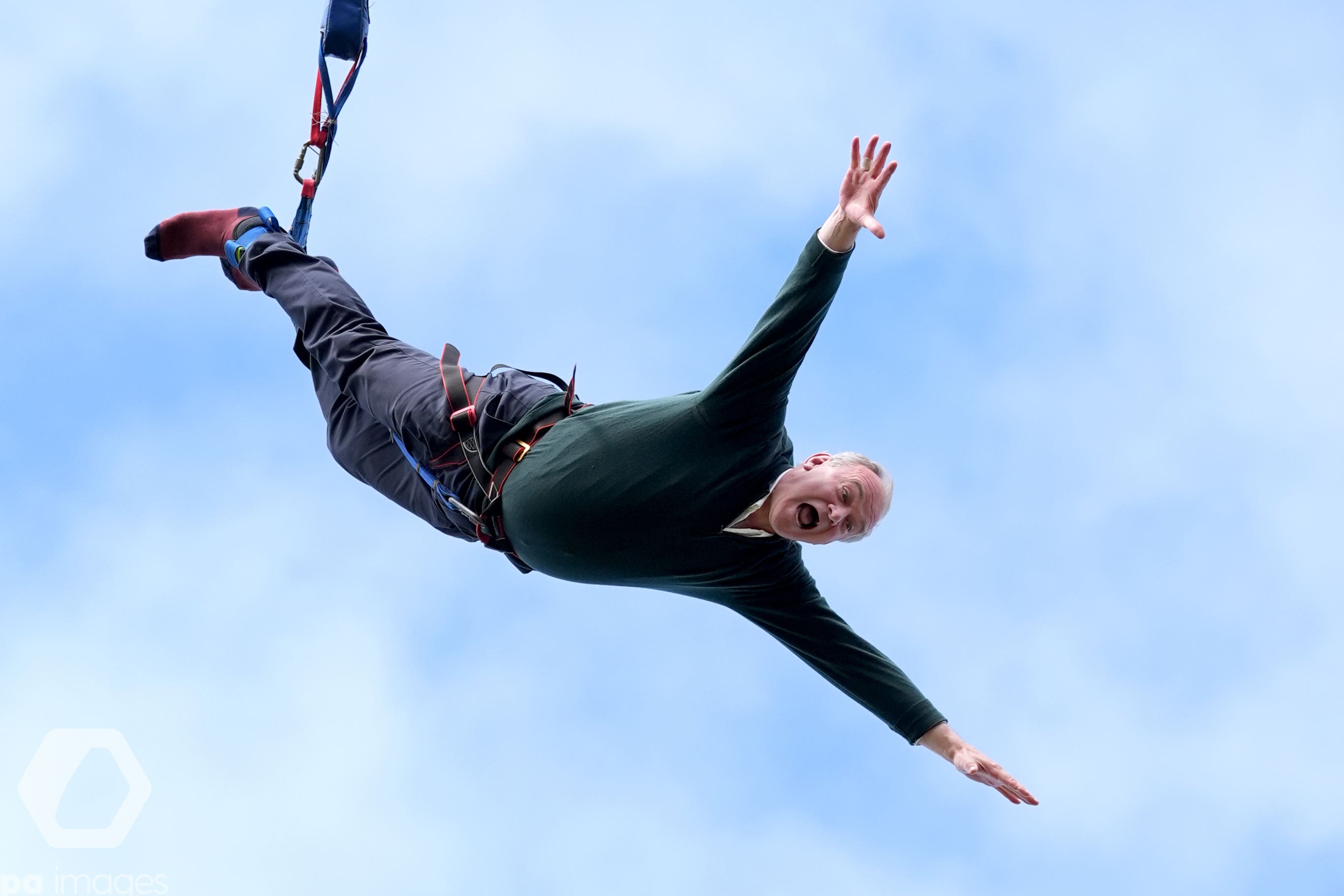 Liberal Democrat leader Sir Ed Davey taking part in a bungee jump during a visit to Eastbourne Borough Football Club in East Sussex, while on the general election campaign trail (PA)