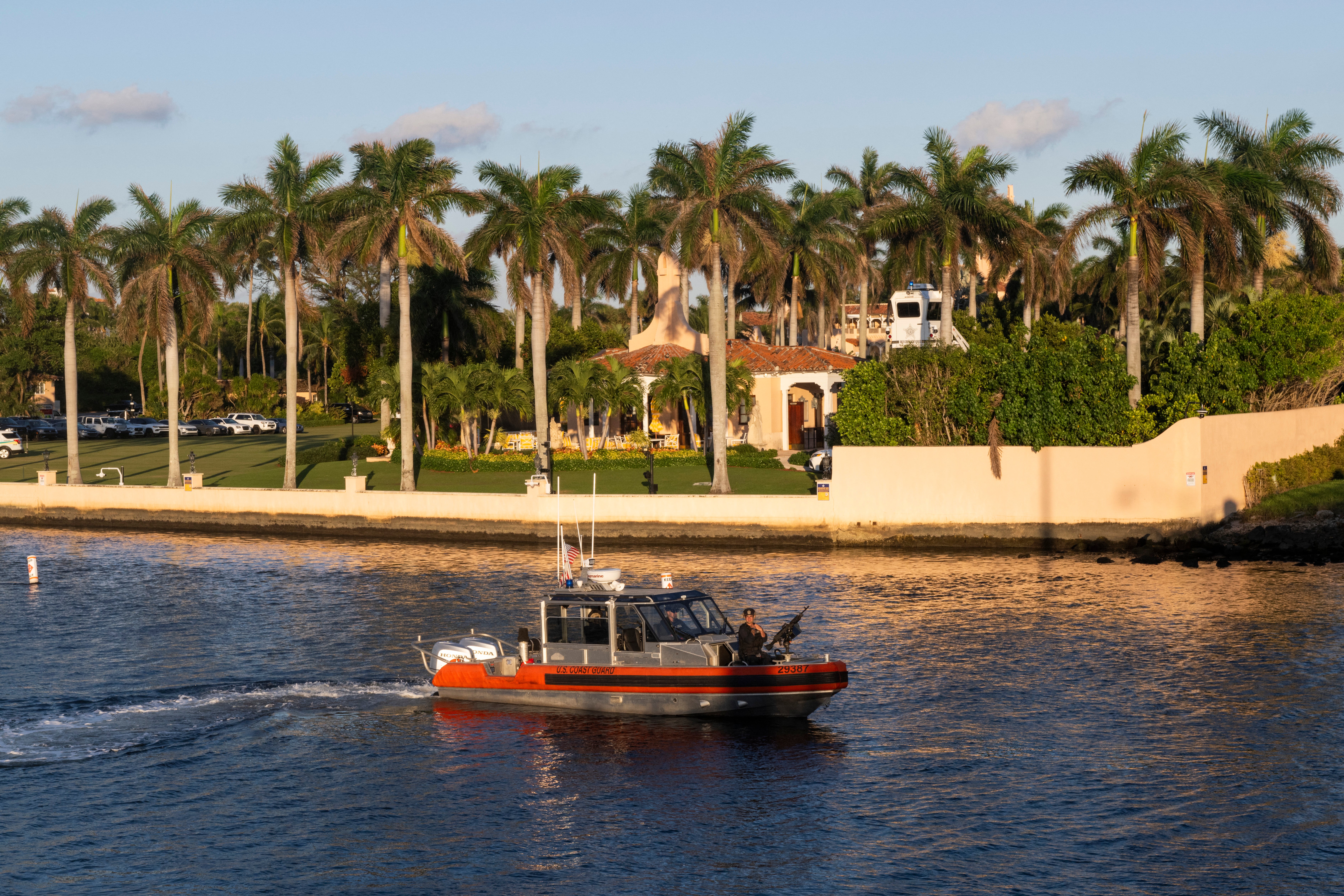 A US Coast Guard boat manned by armed officers patrols the Lake Worth Lagoon off Mar-a-Lago