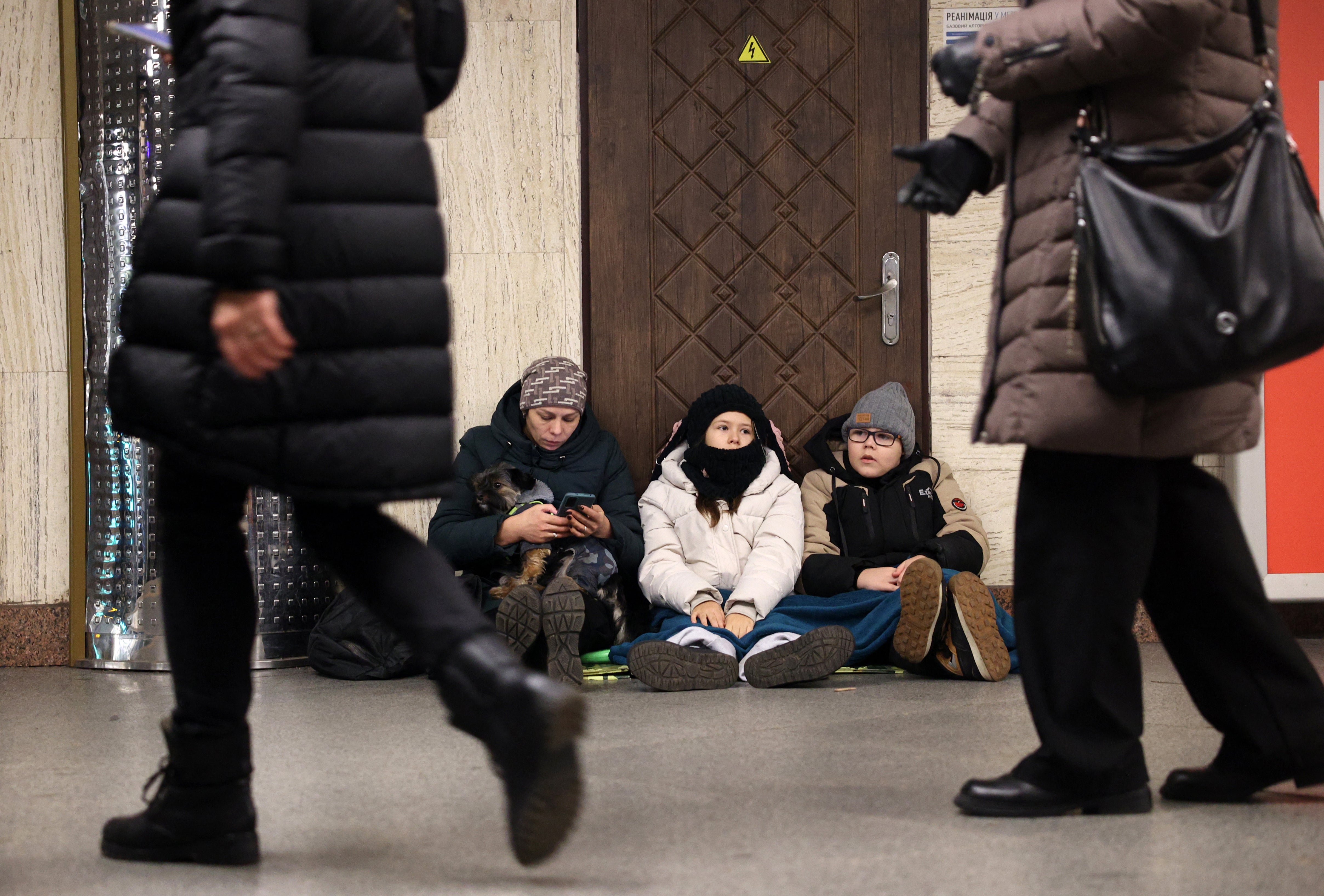 Local residents take shelter in a metro station during an air strike alarm in Kyiv on December 31