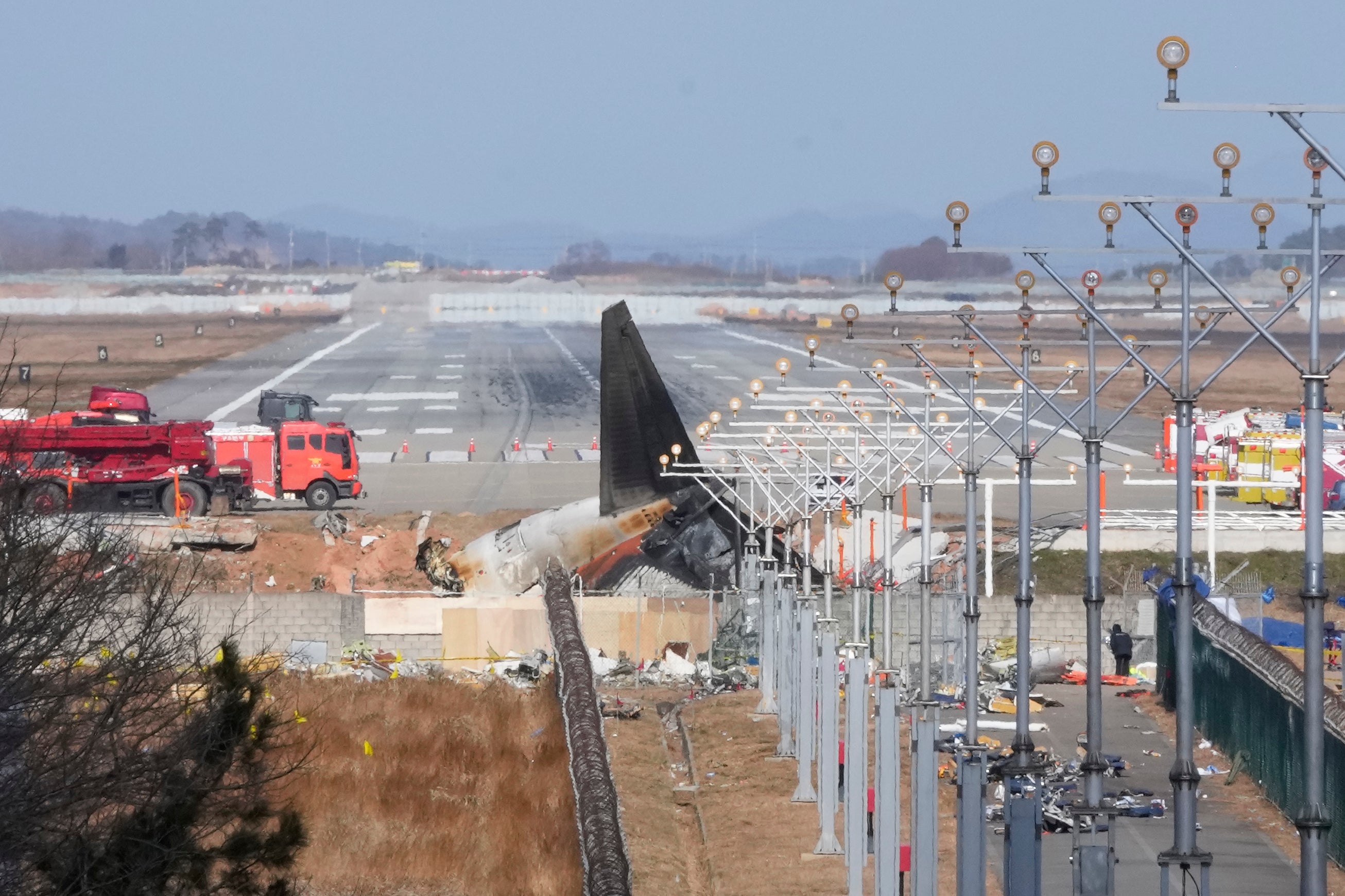 The wreckage of a Boeing 737-800 plane operated by South Korean budget airline Jeju Air lies at Muan International Airport