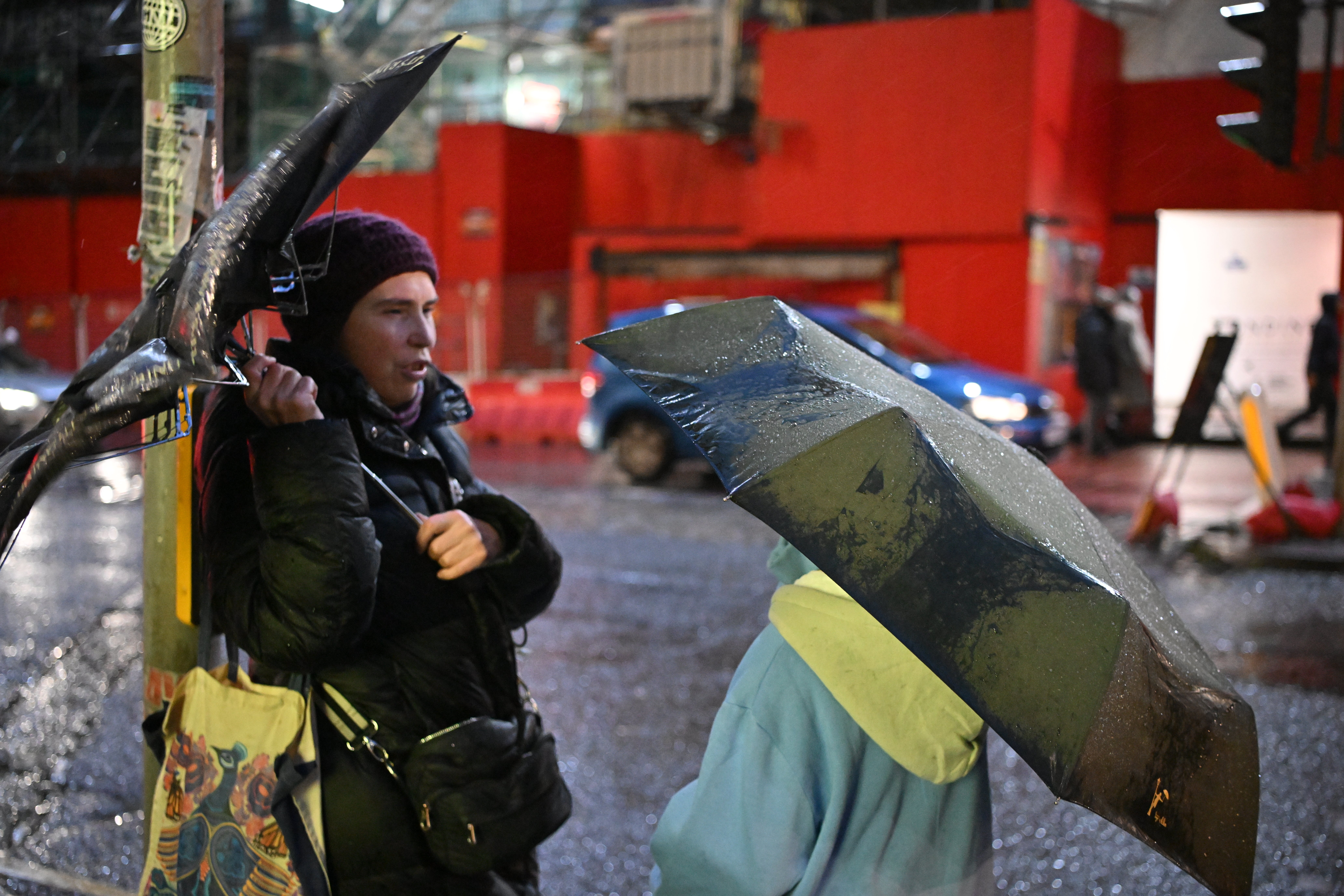 People sheltering from the rain on the street of Edinburgh after the bad weather forced the cancellation of Edinburgh’s Hogmanay outdoor events